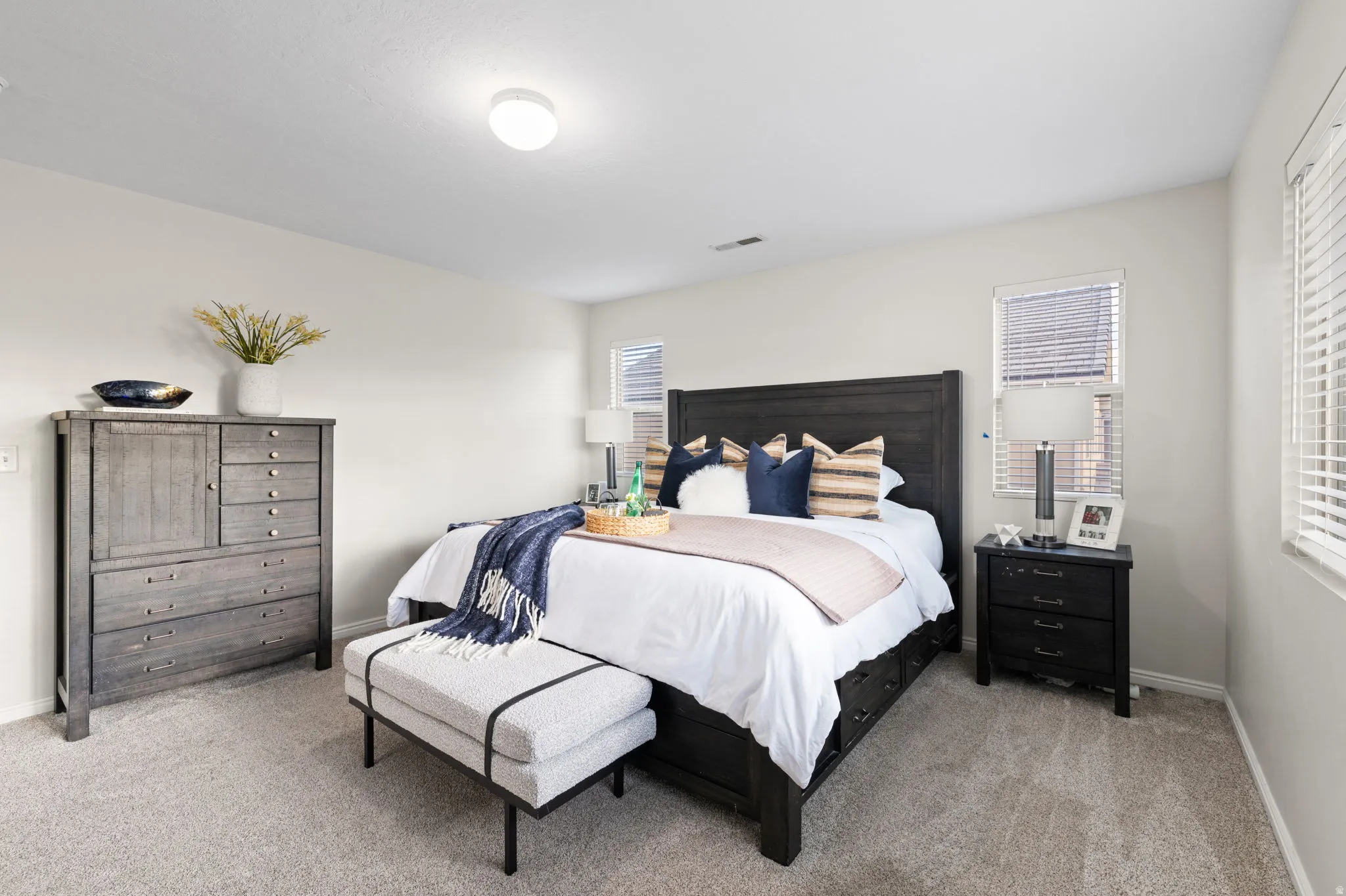 Bedroom with baseboards and light carpet