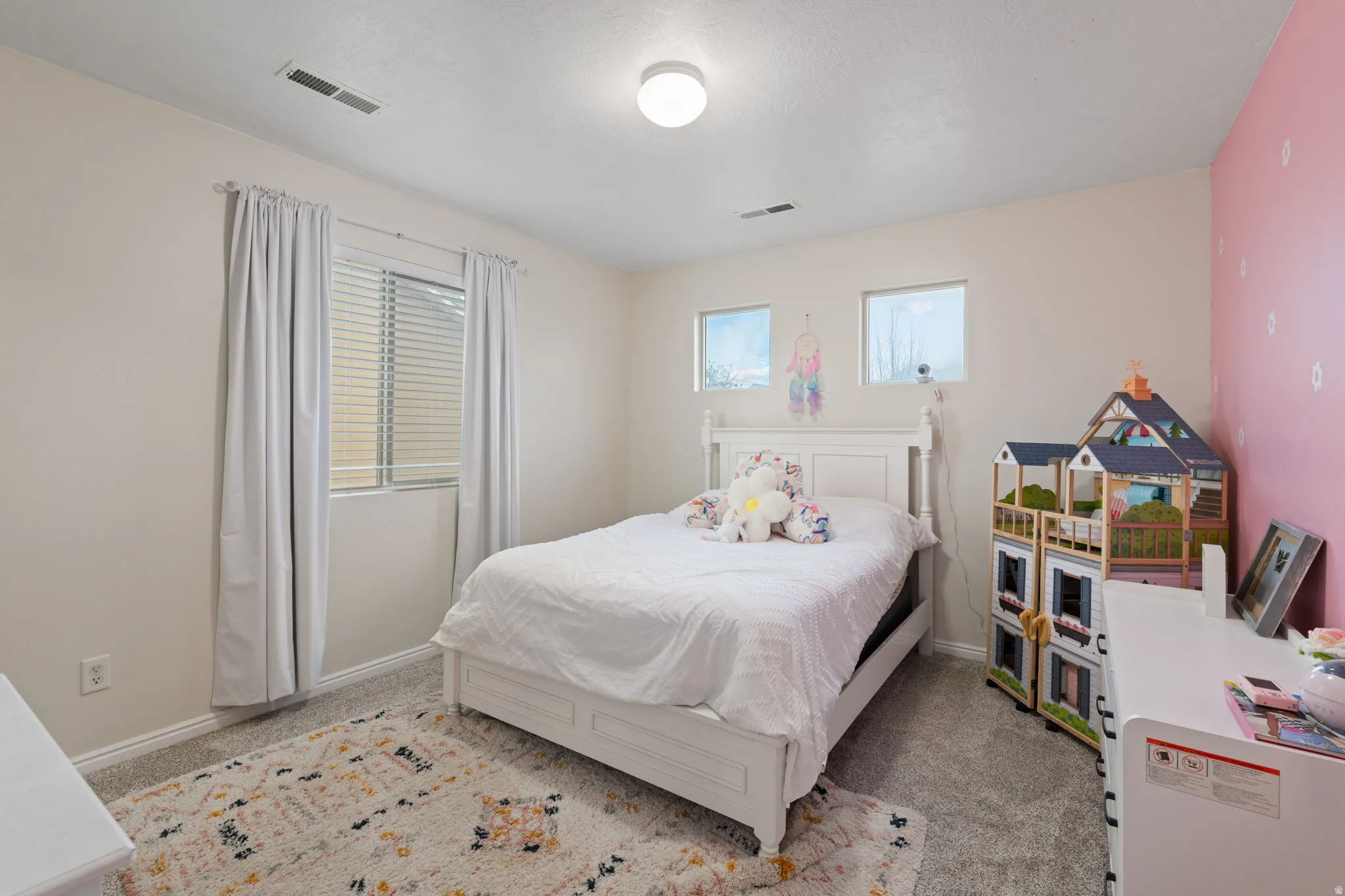 Bedroom featuring baseboards and light carpet