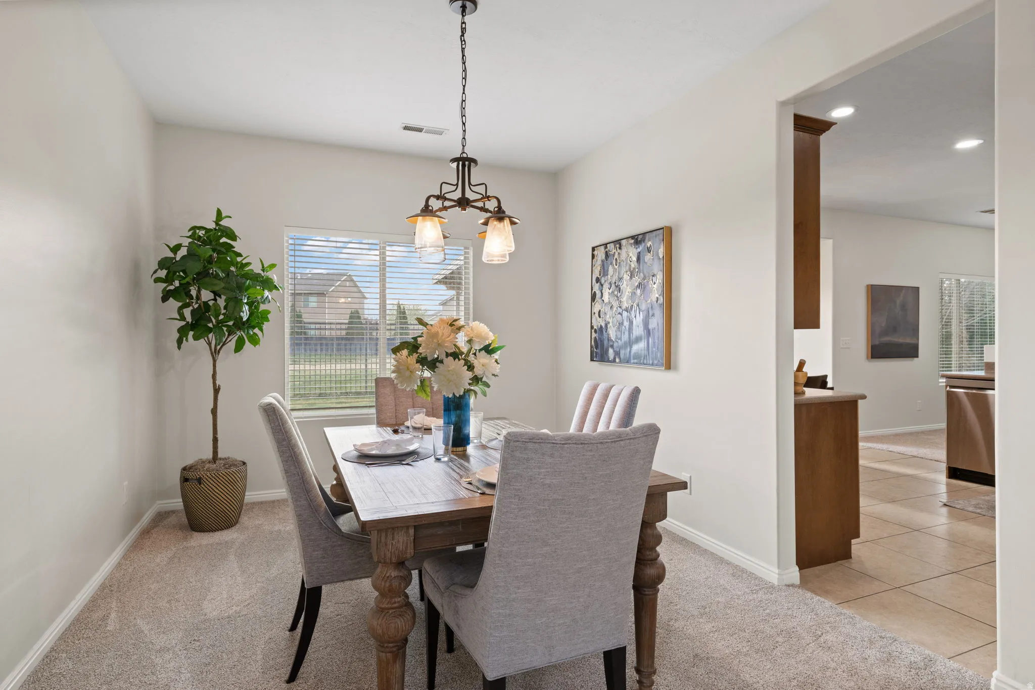 Dining room featuring light colored carpet, light tile patterned floors, and recessed lighting