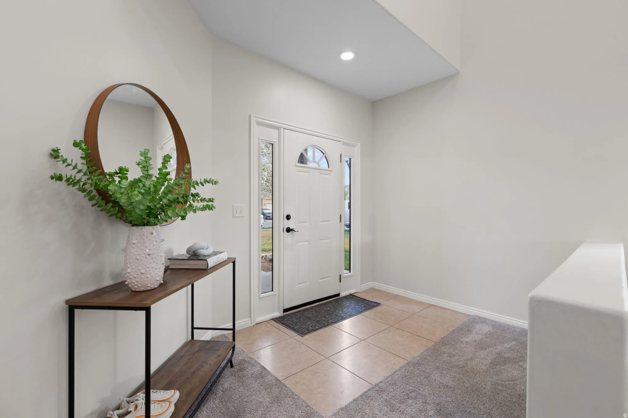 Entrance foyer featuring light tile patterned floors and recessed lighting