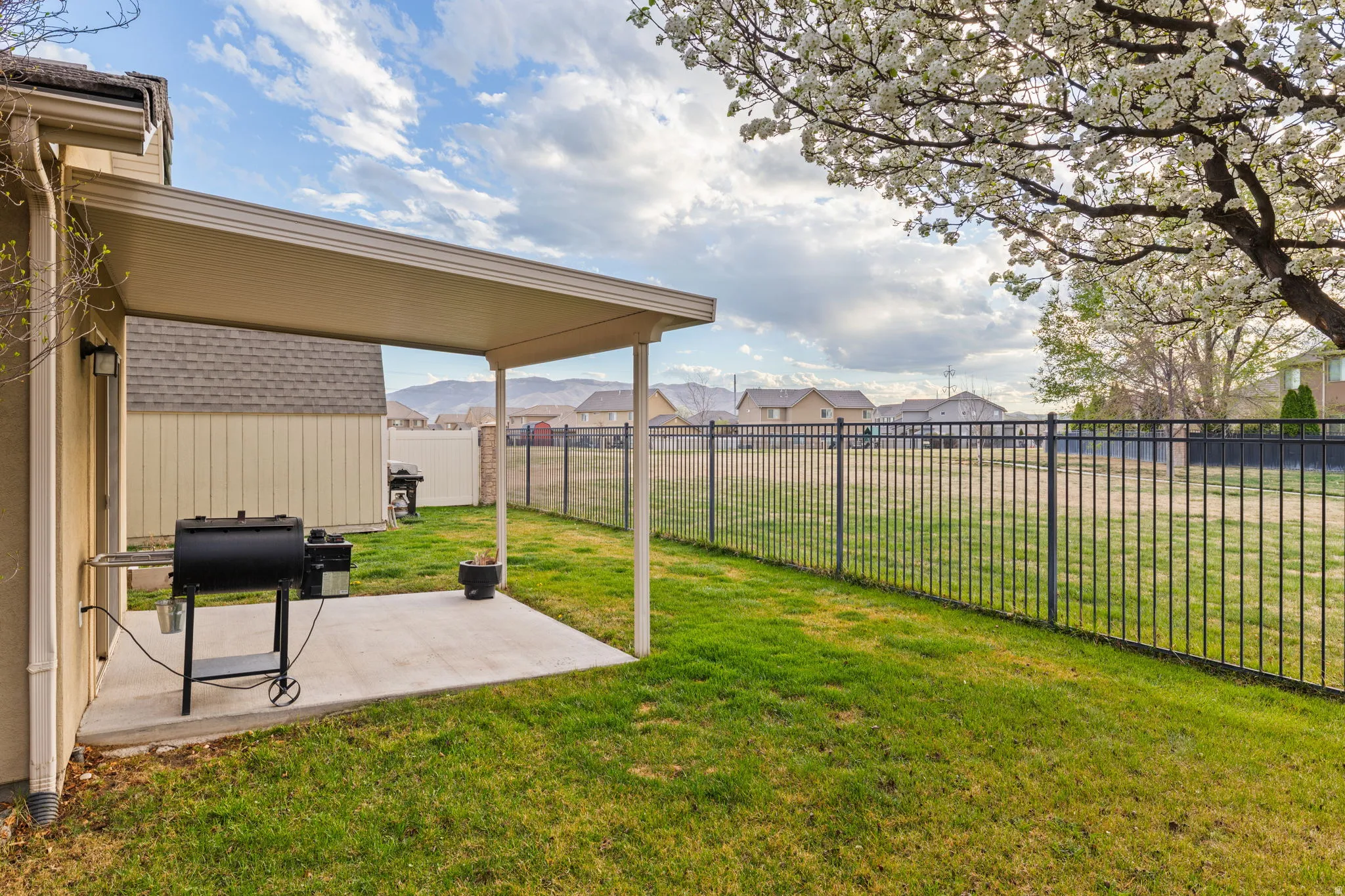 Fenced backyard with a residential view and a patio area