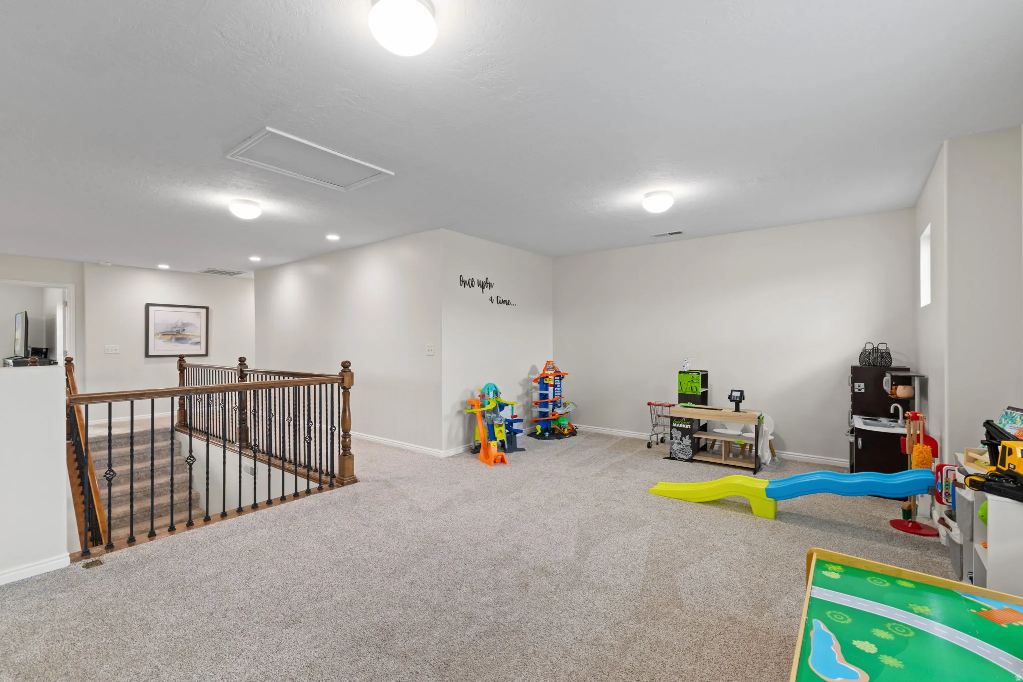 Playroom featuring attic access and carpet flooring