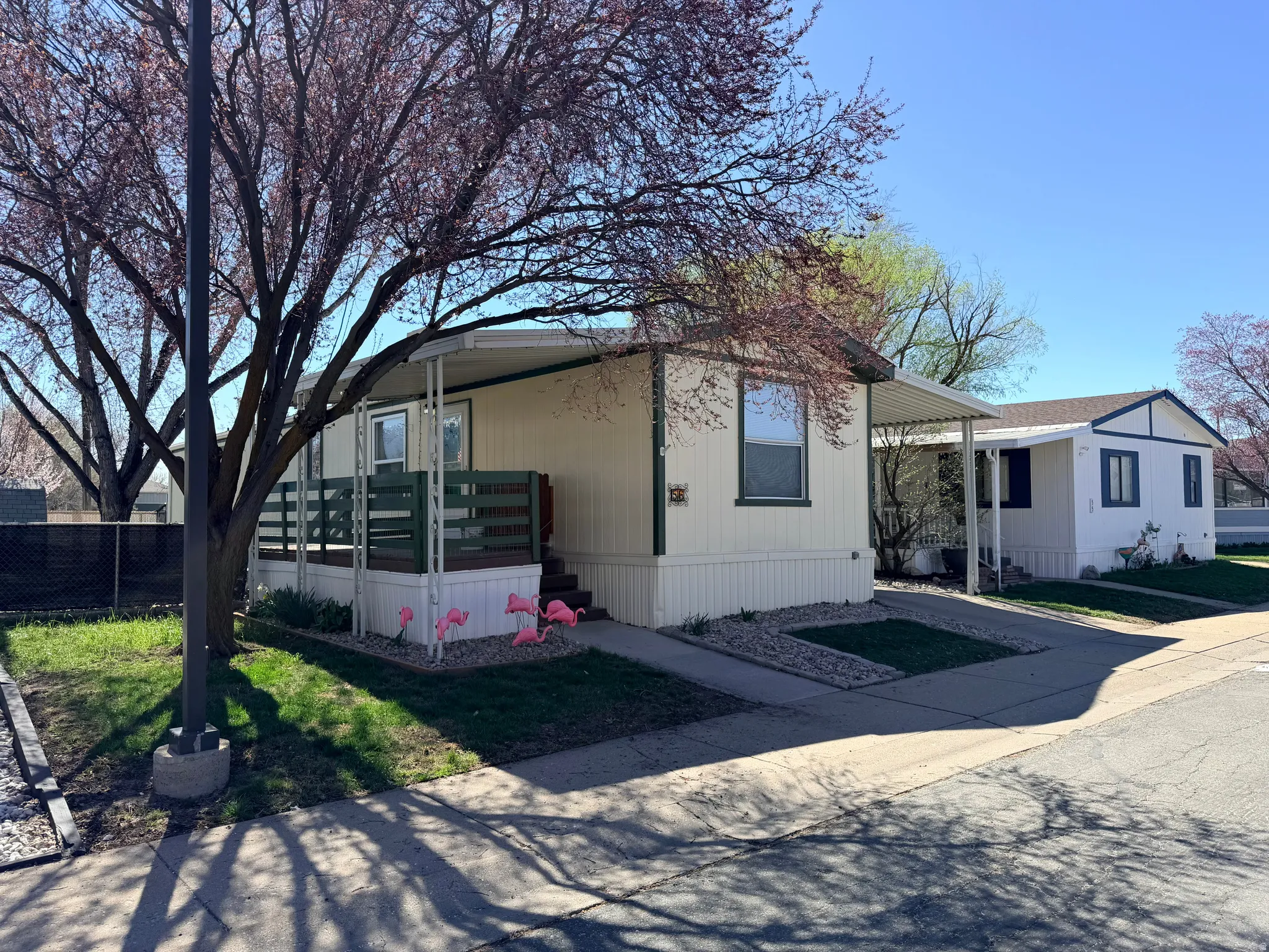 Manufactured / mobile home featuring a carport and concrete driveway