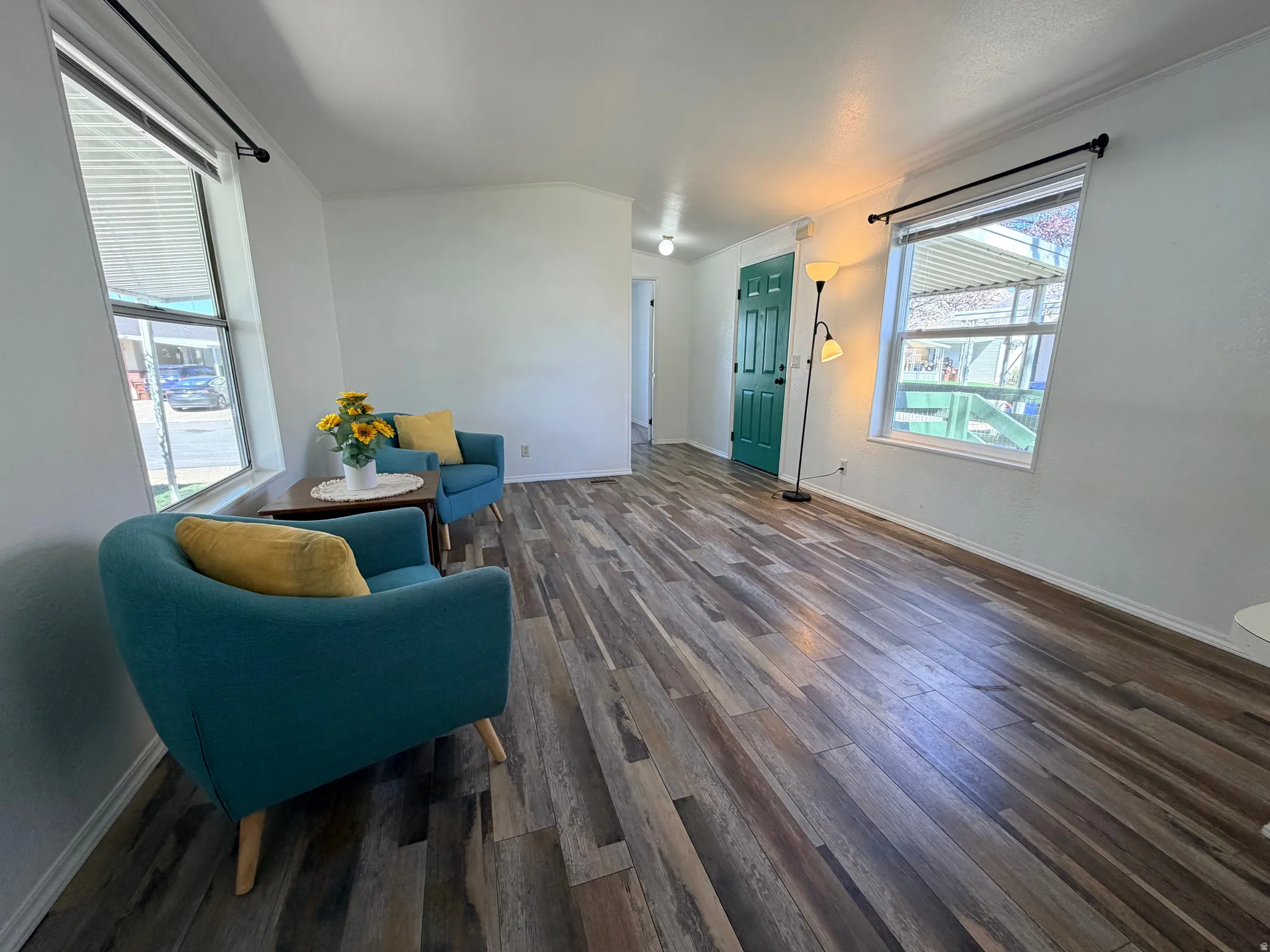 Sitting room featuring dark wood-style floors