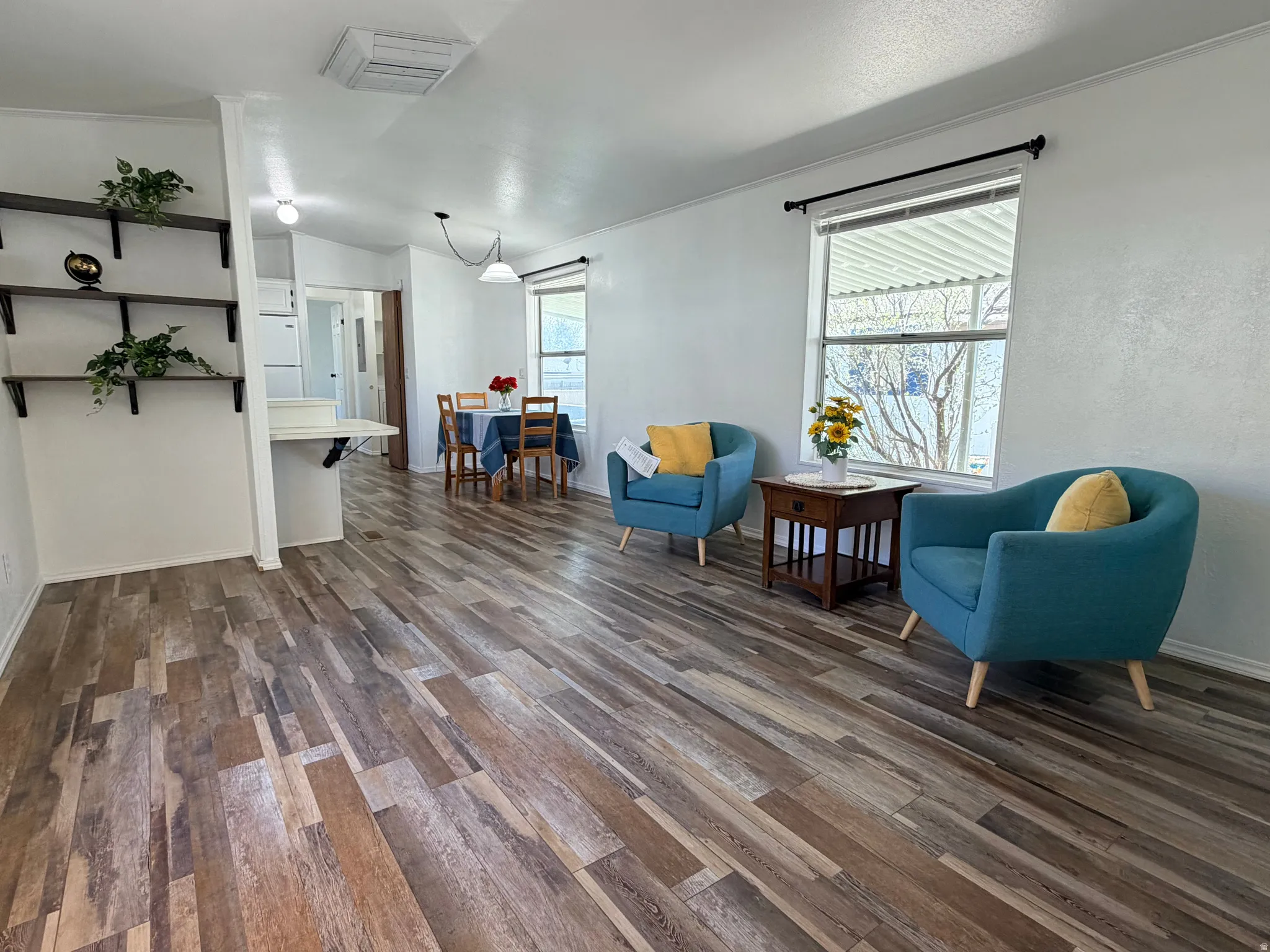 Living area with dark wood finished floors and cooling unit