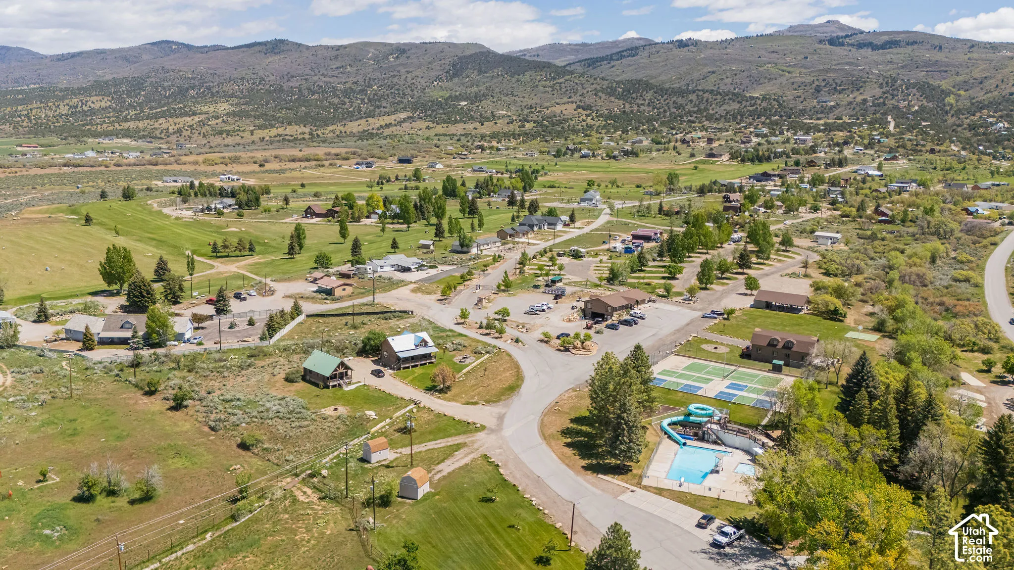 Aerial overview of property's location with mountains and a pool area