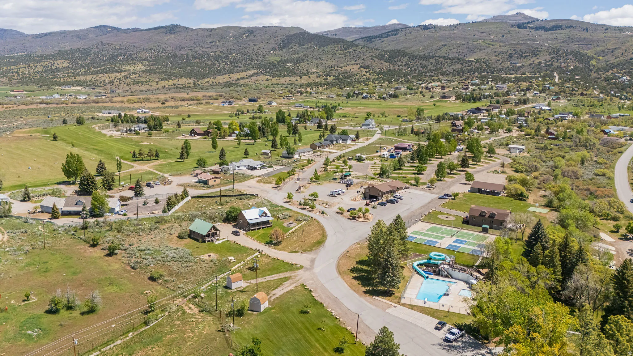 Aerial overview of property's location with mountains and a pool area