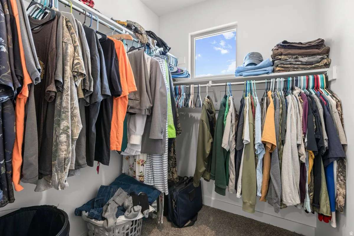 Walk in closet featuring carpet flooring