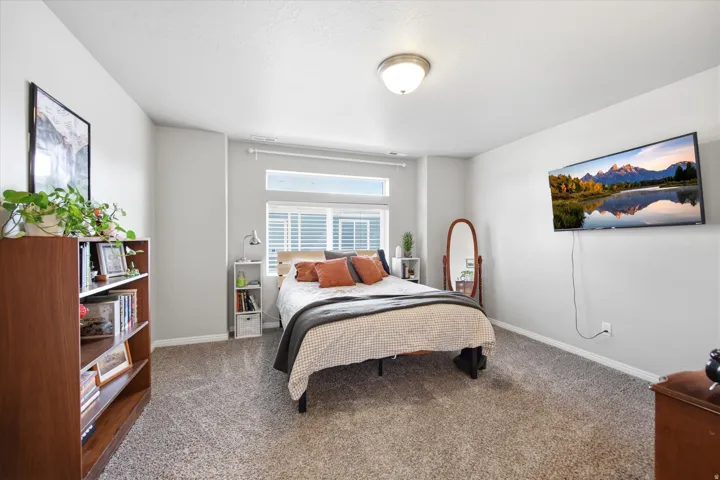 Carpeted bedroom featuring baseboards