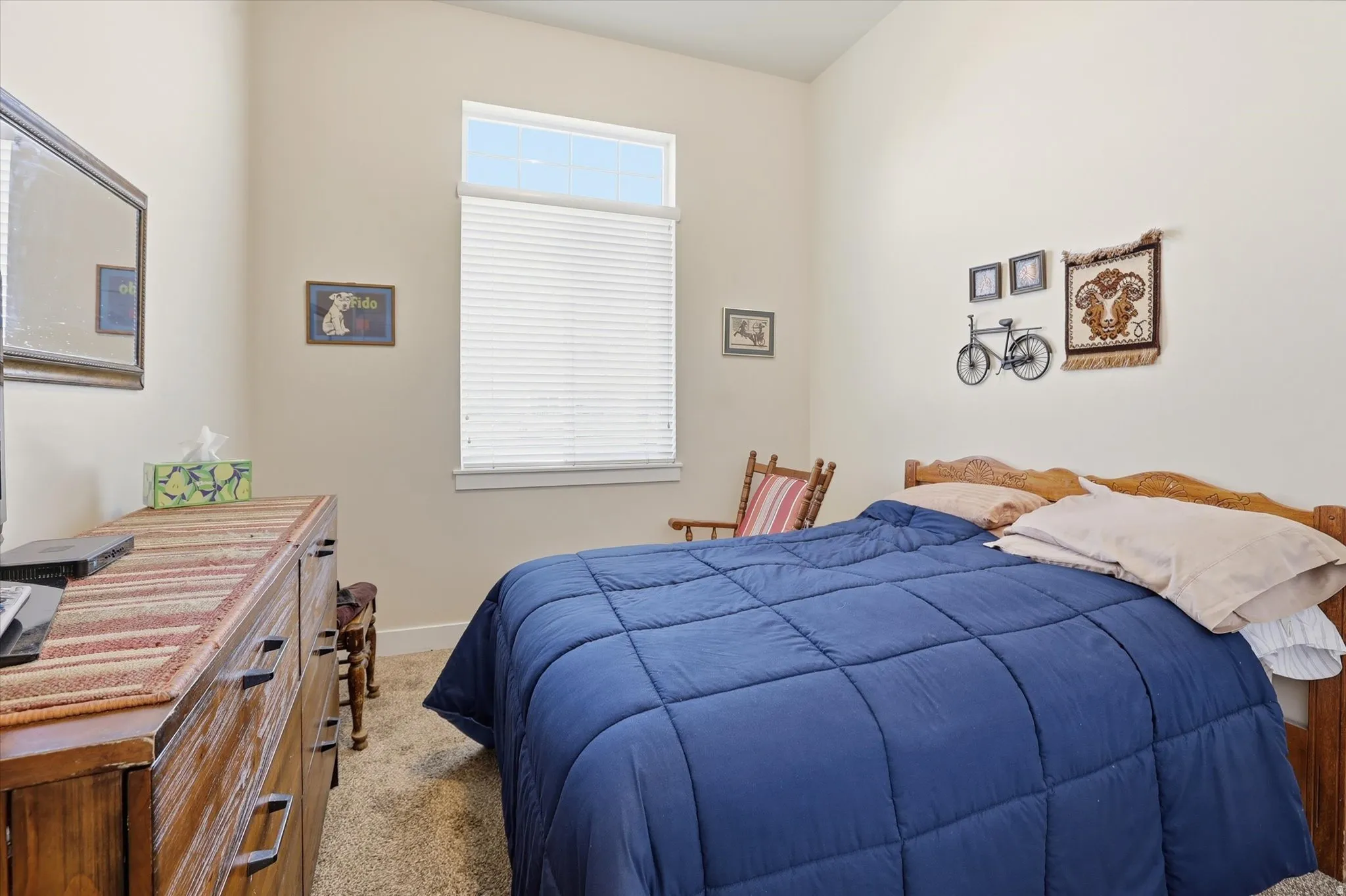 Bedroom with light carpet and baseboards