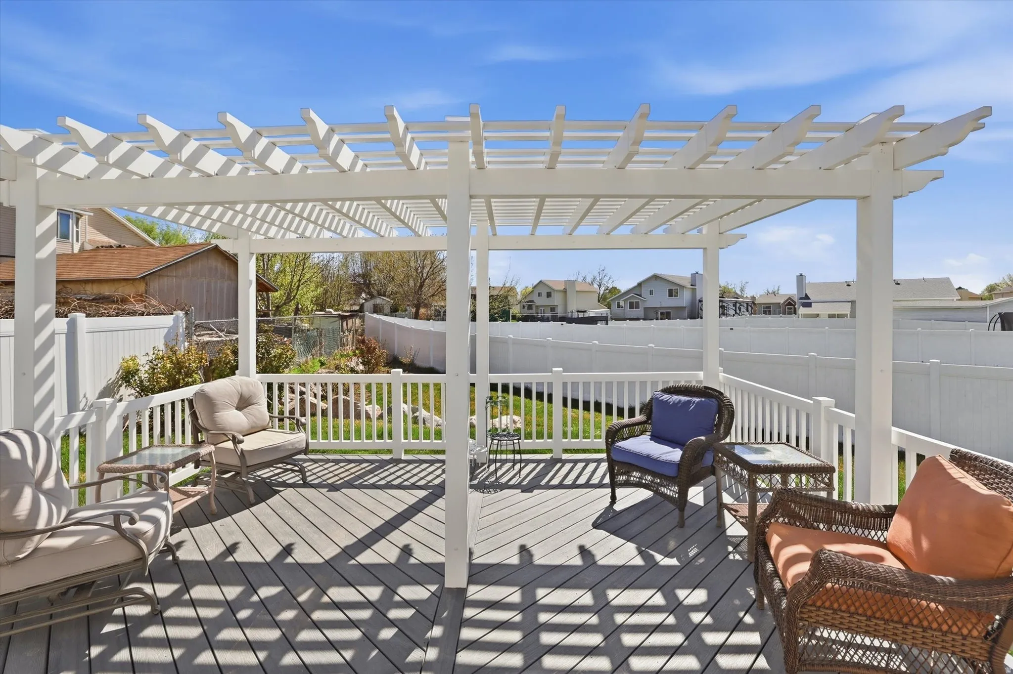Wooden terrace featuring a fenced backyard, a residential view, and a pergola