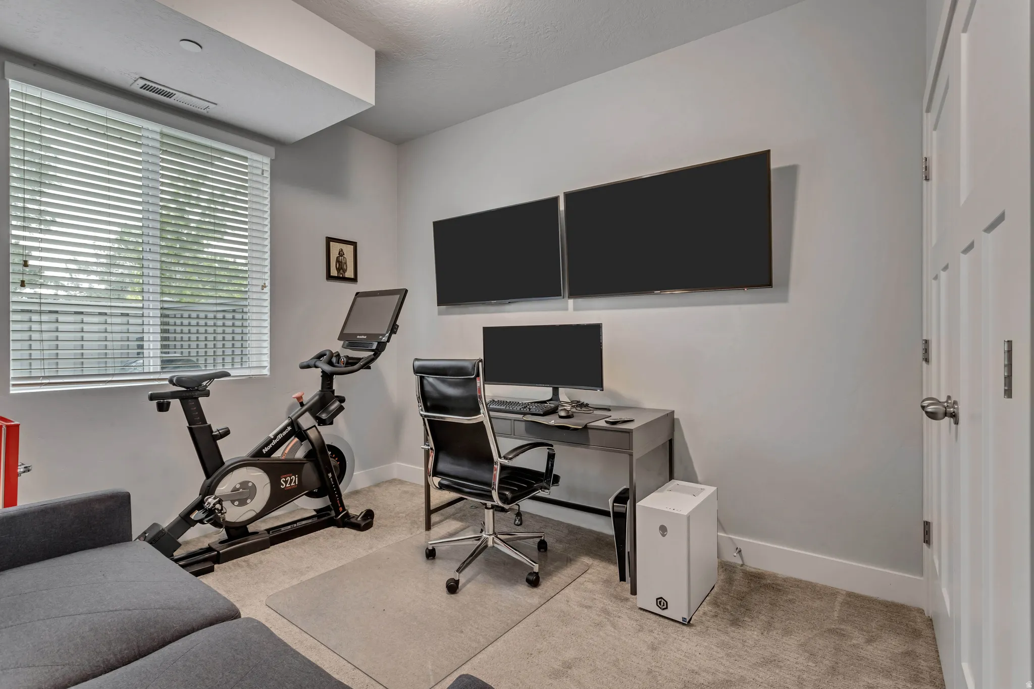 Bedroom/Office room with light colored carpet and baseboards