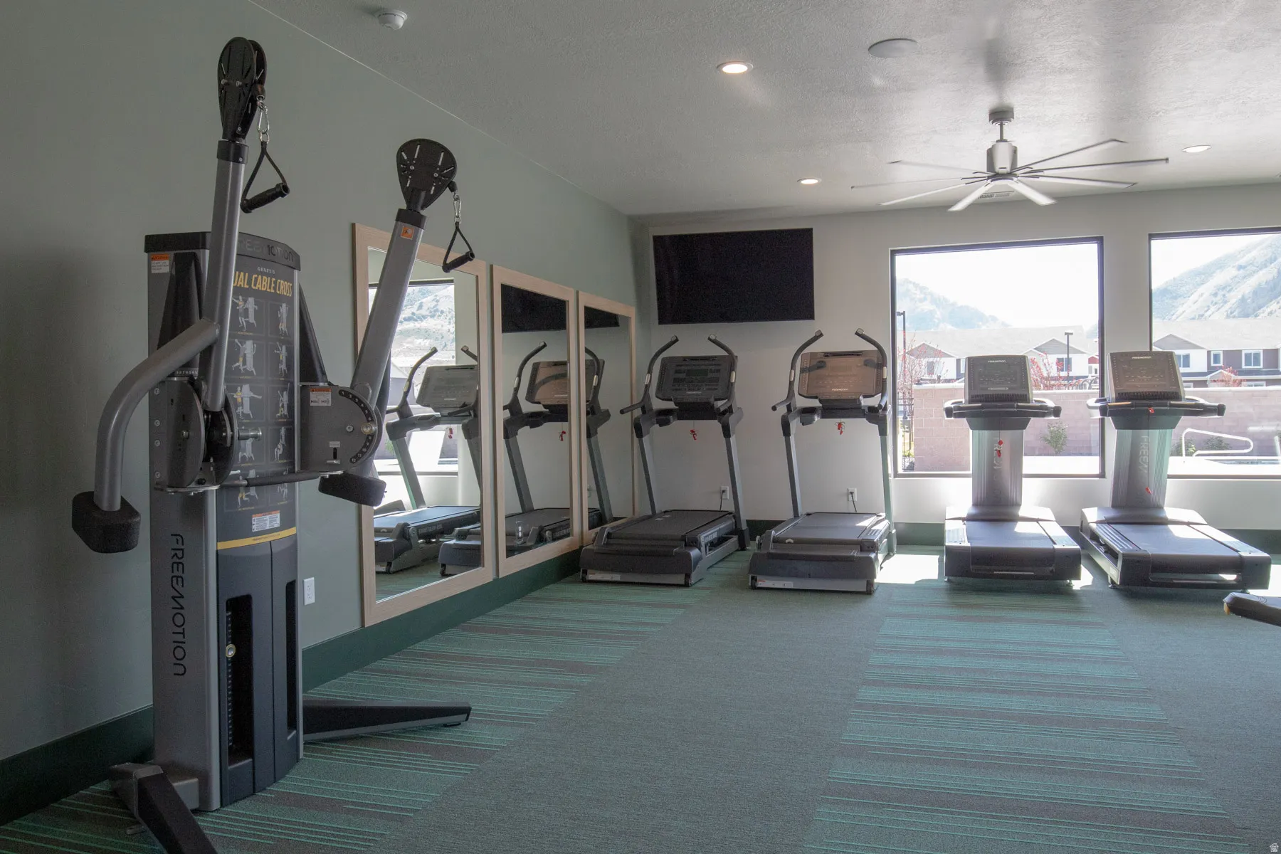 Gym with ceiling fan and recessed lighting