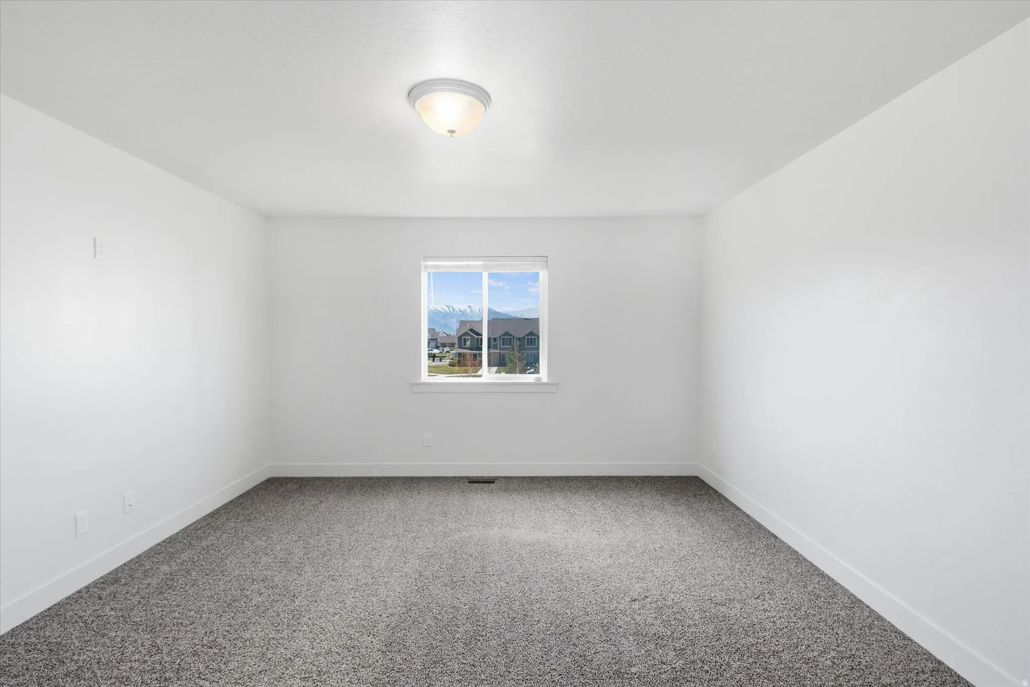 Primary Bedroom Carpeted empty room with baseboards