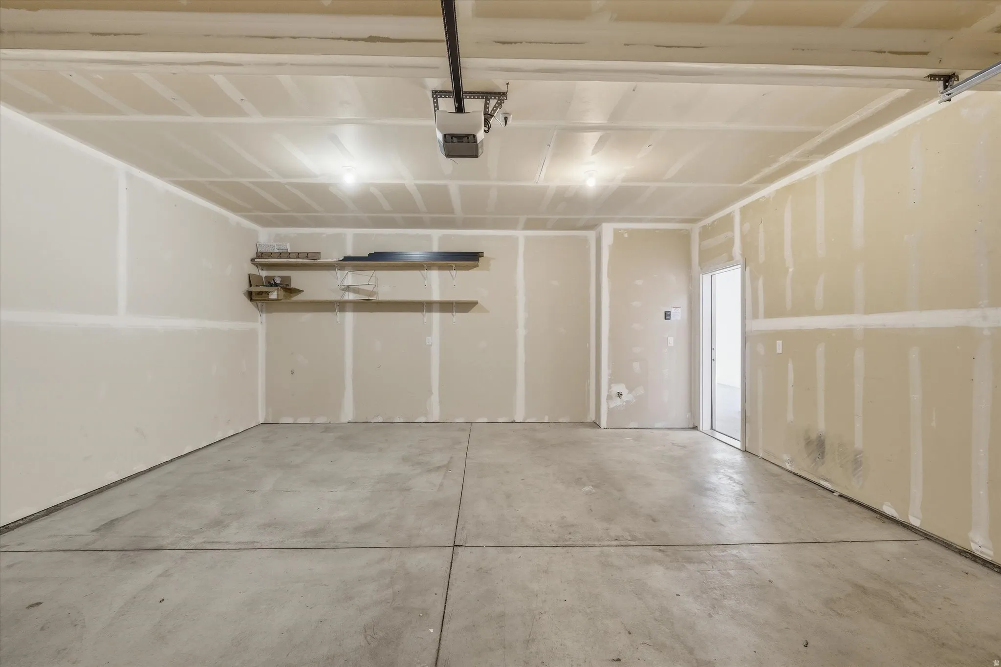 Garage featuring a garage door opener