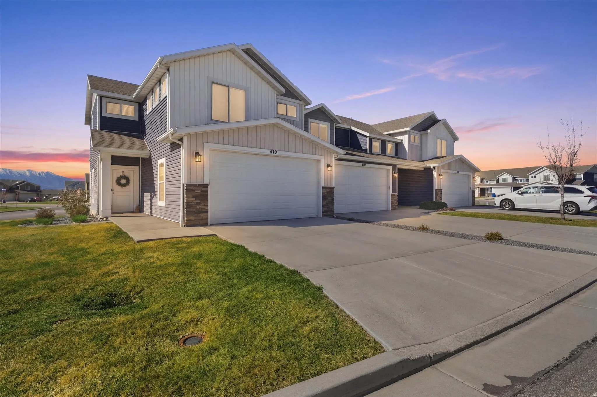 View of front facade with driveway and a garage