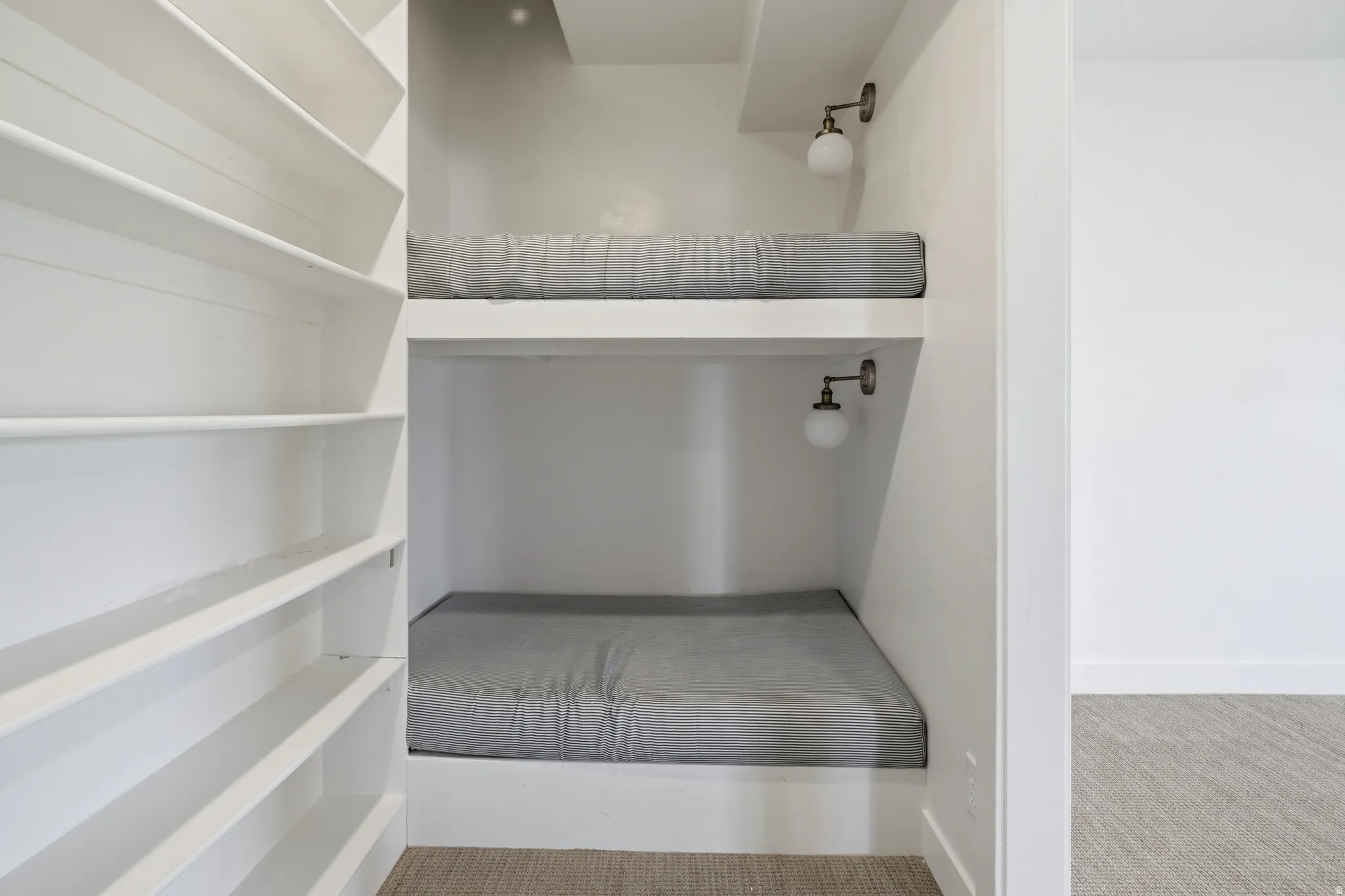 Built-in bunk beds featuring individual sconce lighting