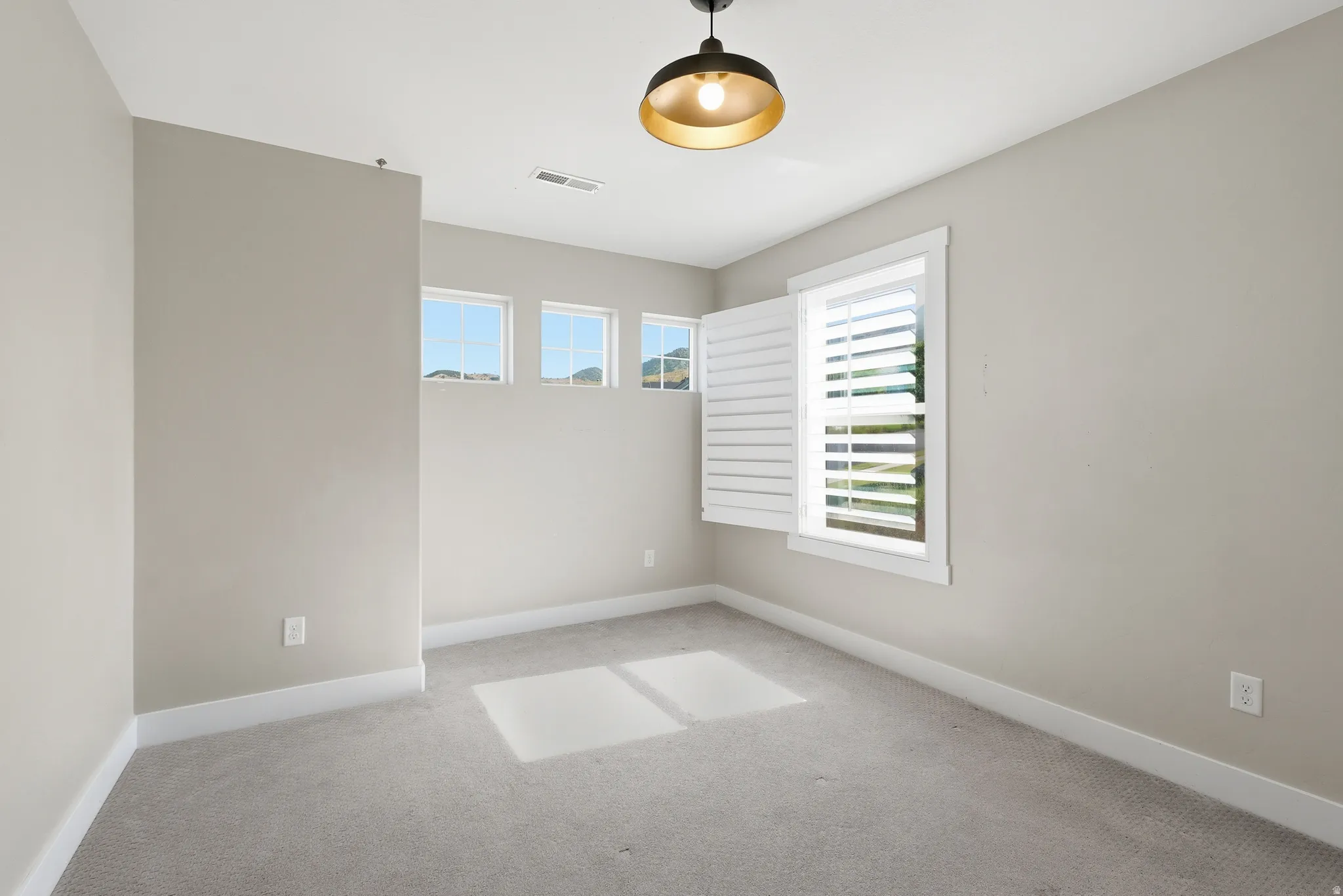 Neutral tone wall paint with white baseboards and trim