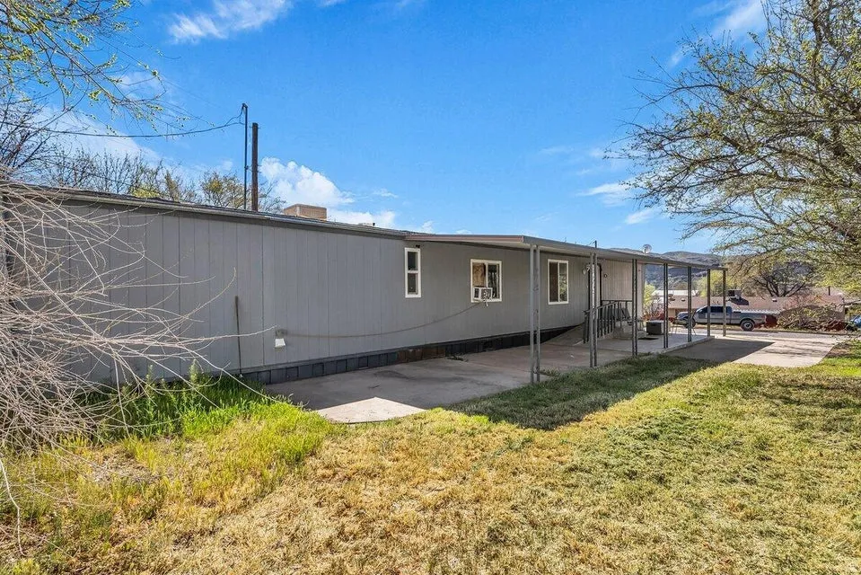 Back of property featuring a yard and a patio area