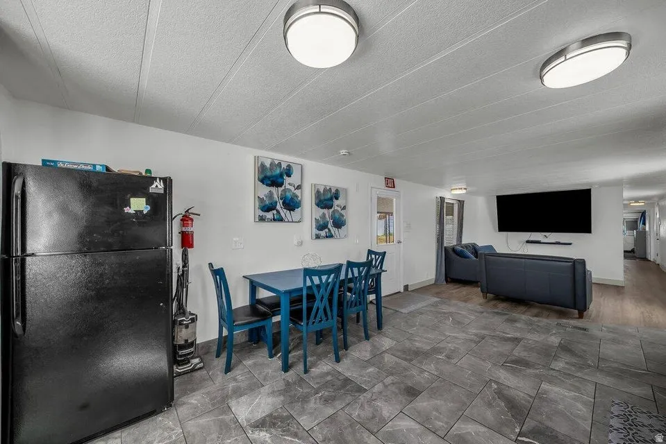 Dining area featuring stone finish flooring and a textured ceiling