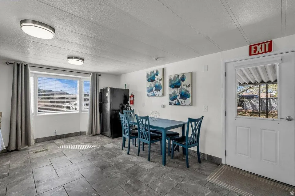 Dining area featuring a textured ceiling and baseboards