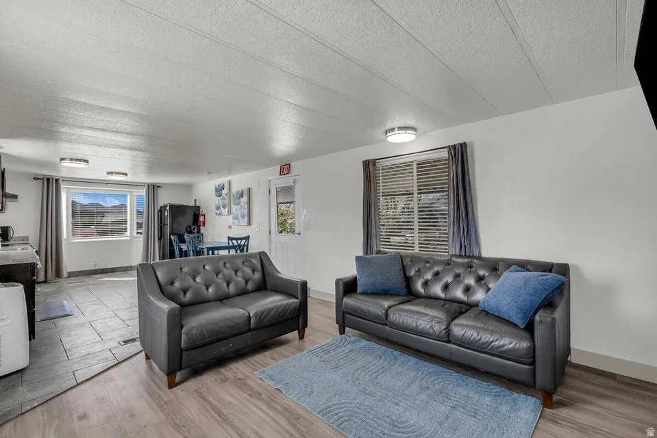 Living room with a textured ceiling and wood finished floors