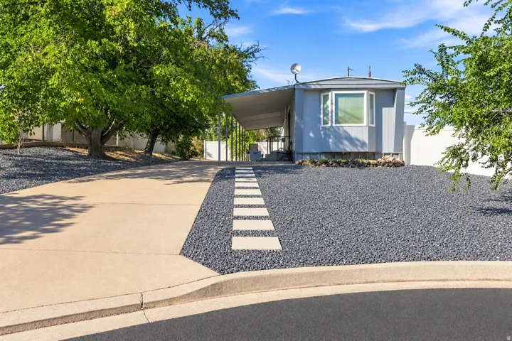 Expansive driveway leading to a covered carport