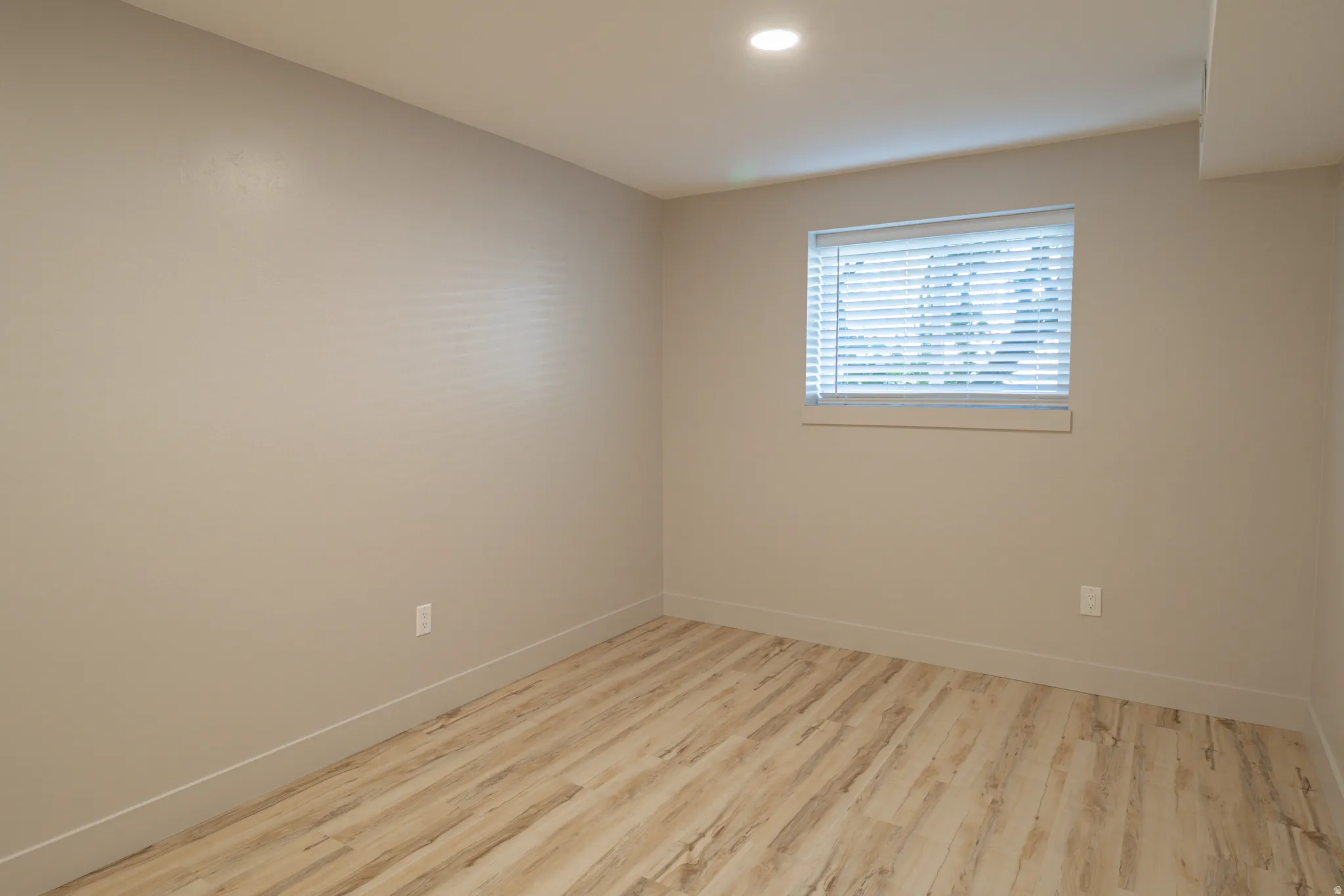 Spare room featuring light wood-style floors and recessed lighting
