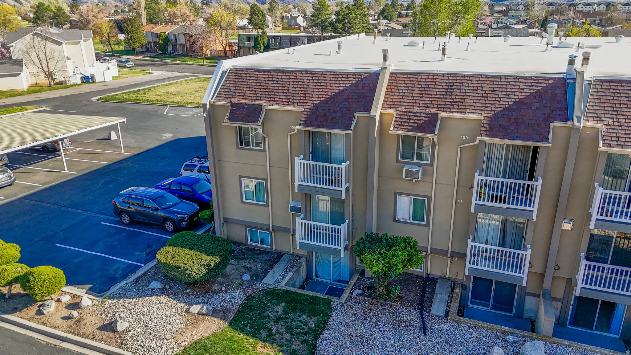 View of property featuring uncovered parking and a residential view