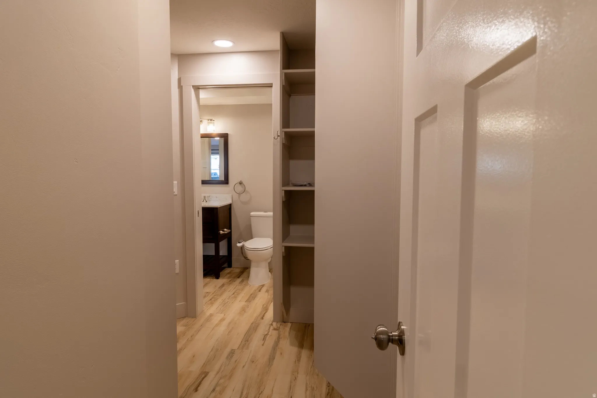 Hallway featuring light wood-style floors