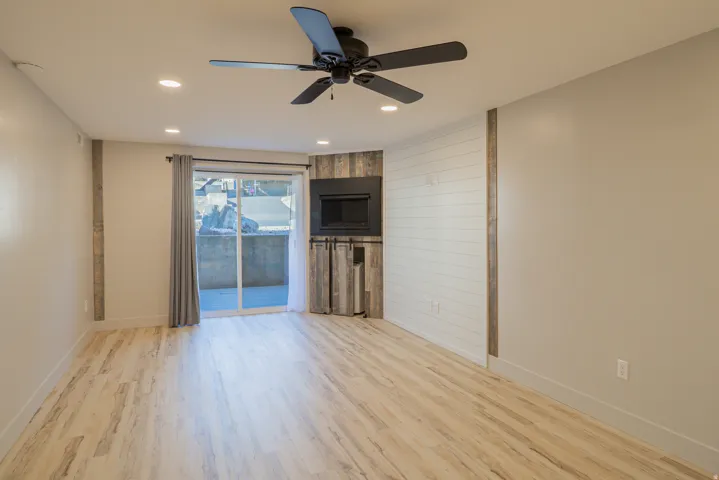 Unfurnished living room with ceiling fan, light wood-type flooring, and recessed lighting