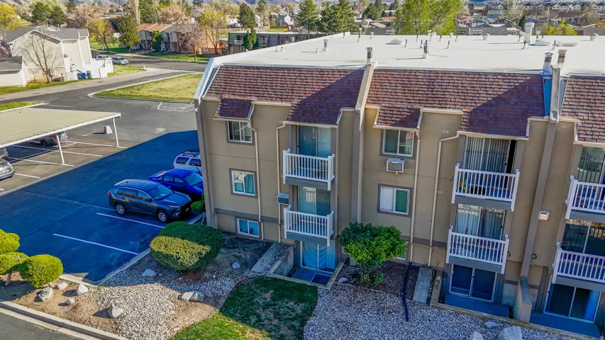 View of property featuring uncovered parking and a residential view