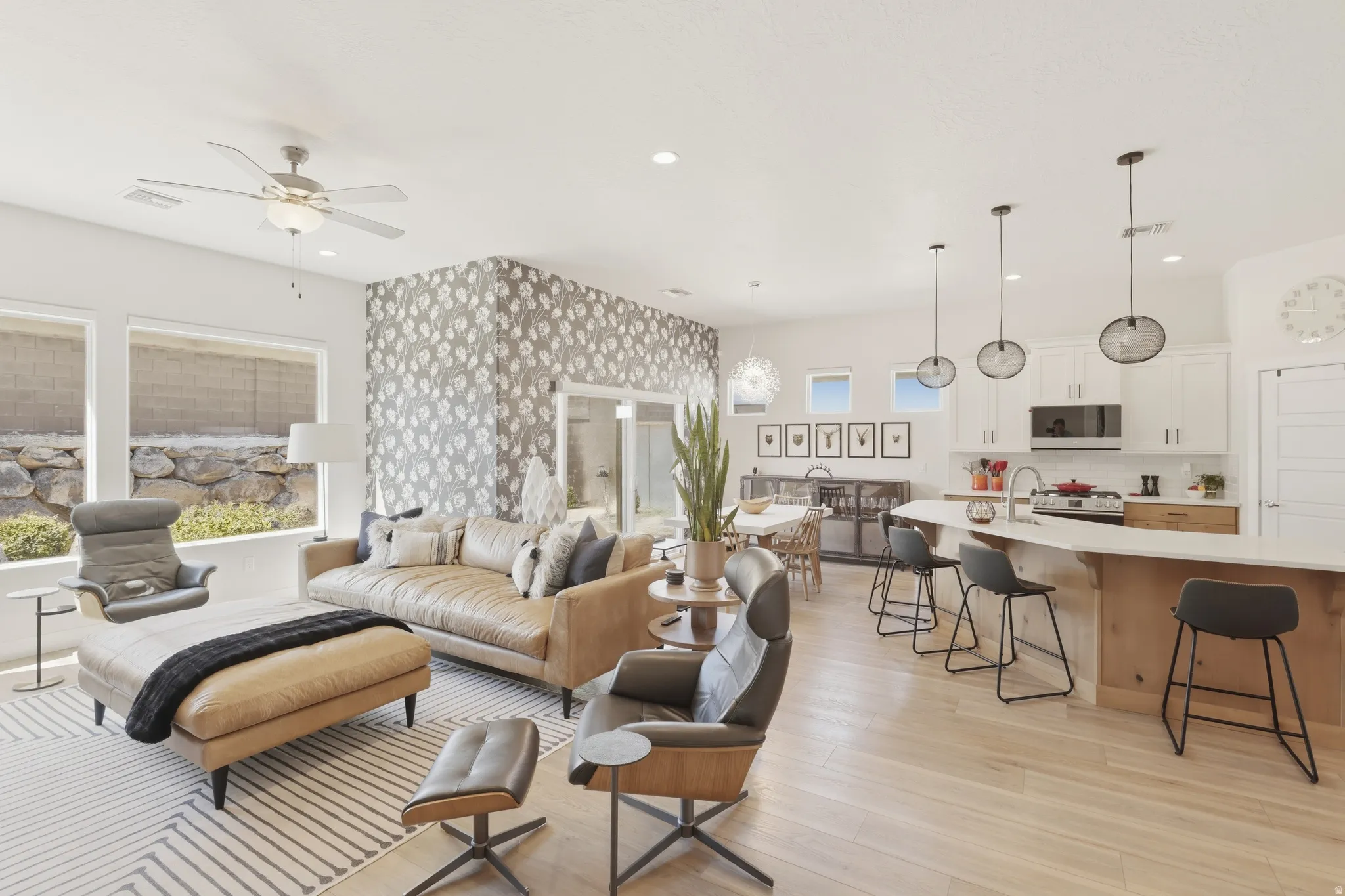 Living area featuring light wood finished floors, ceiling fan, and recessed lighting