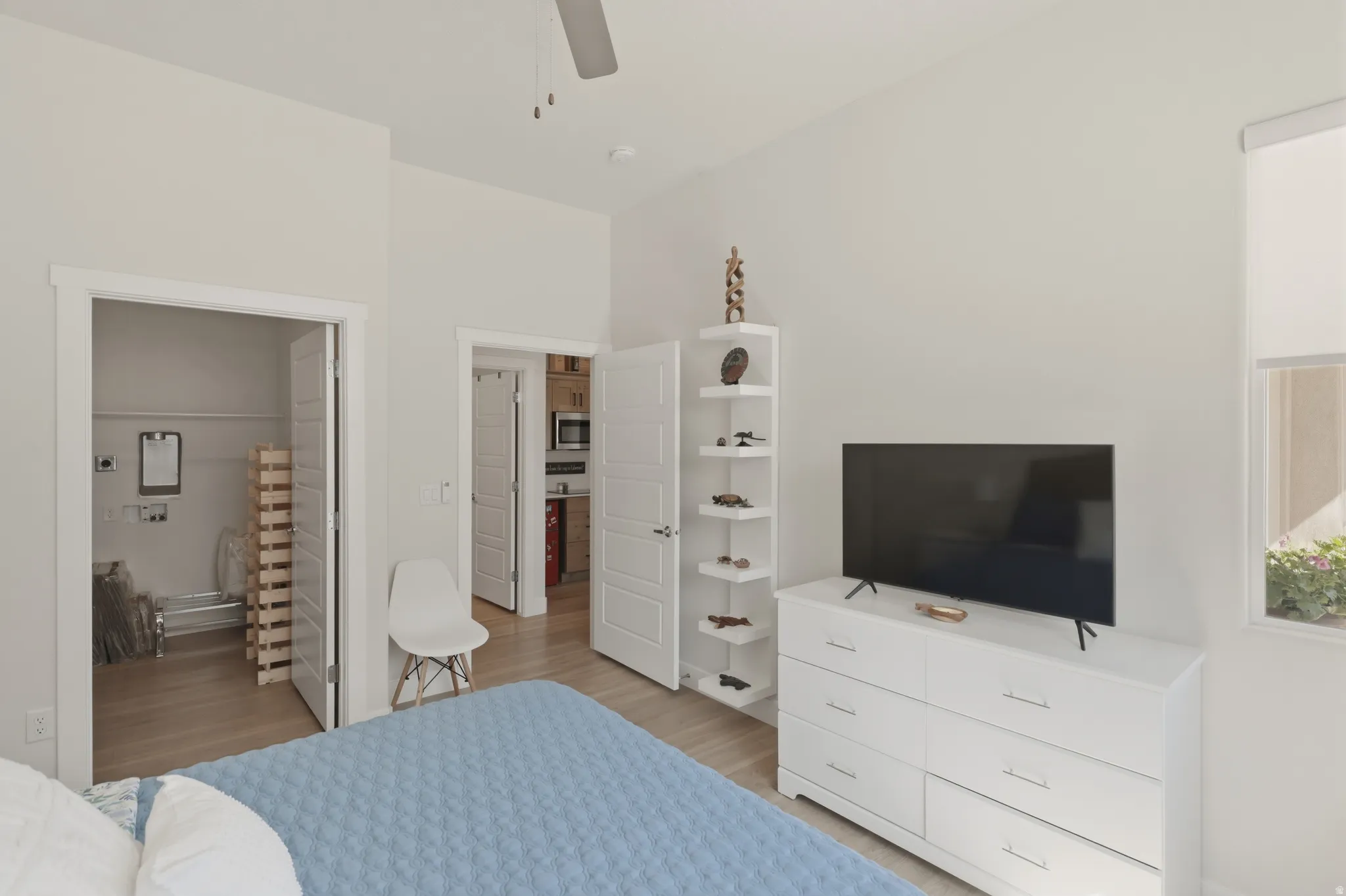 Bedroom with light wood finished floors and a ceiling fan