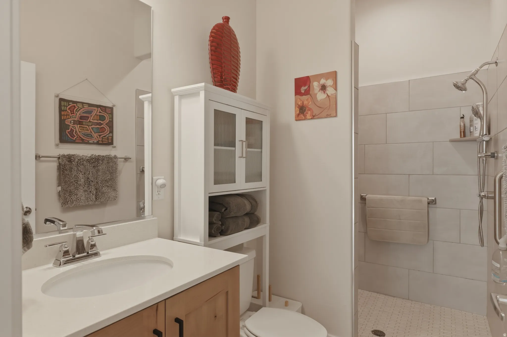Full bathroom with vanity and tiled shower