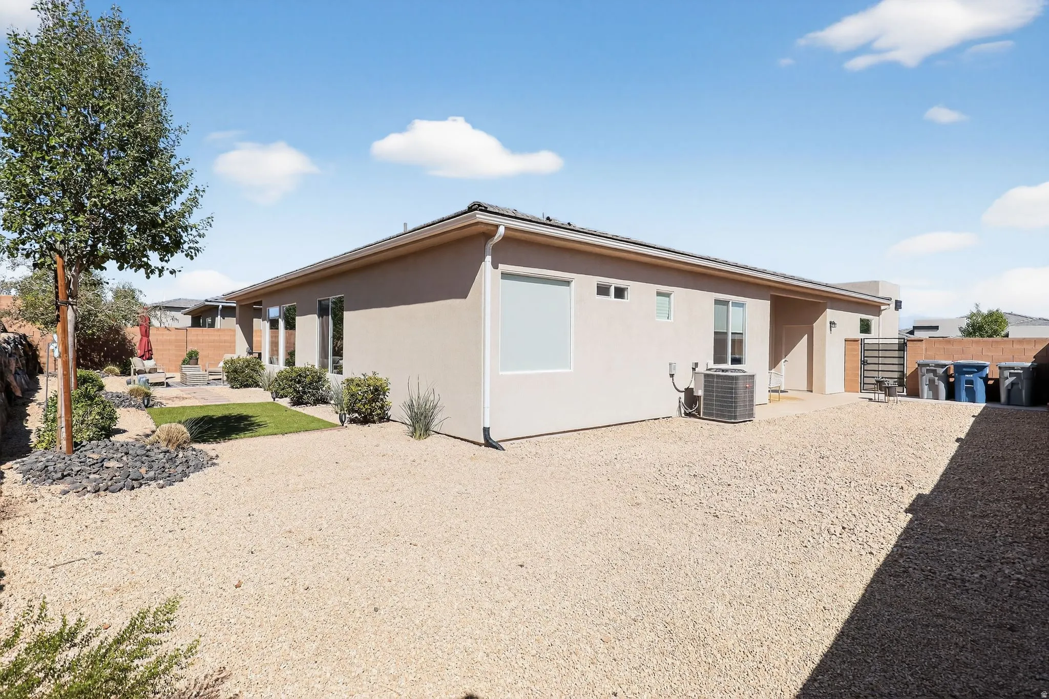 Rear view of property with a patio, a fenced backyard, and stucco siding