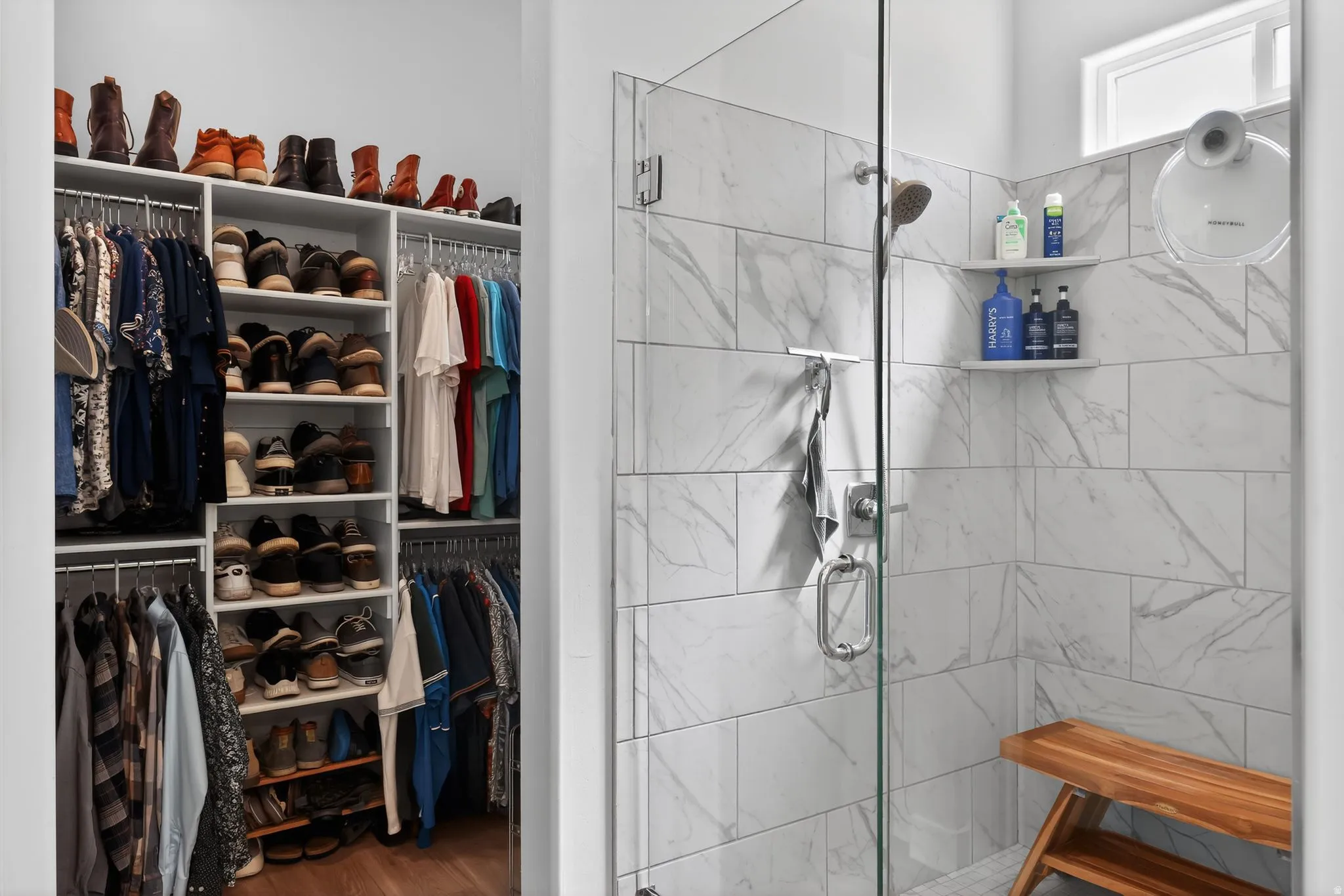 Bathroom with a stall shower, dark wood-style flooring, and a spacious closet
