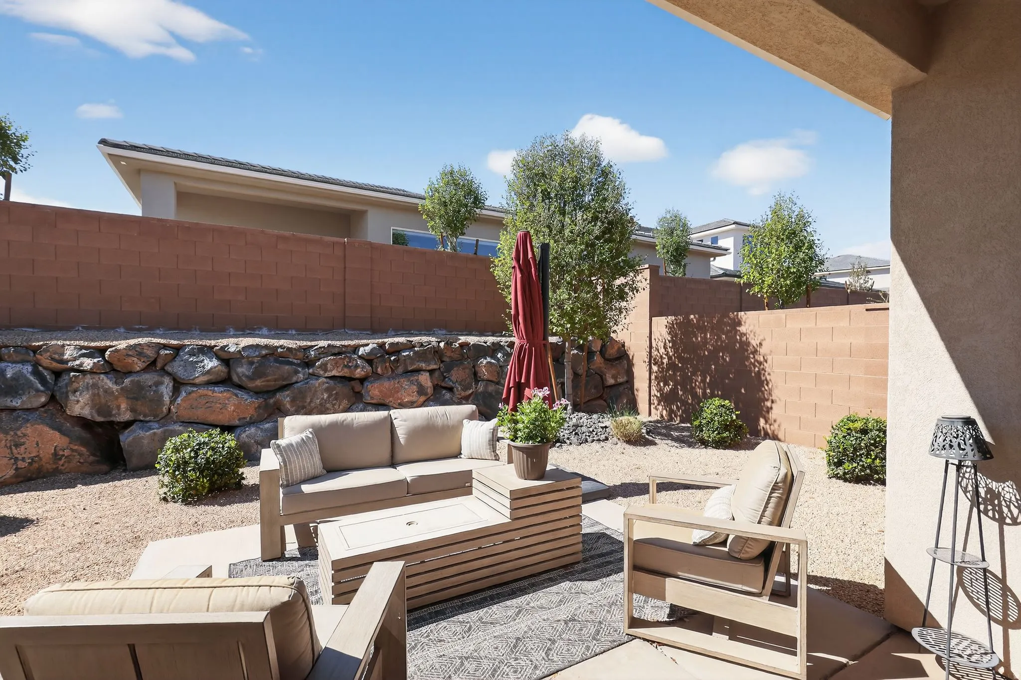 Fenced backyard with an outdoor hangout area and a patio