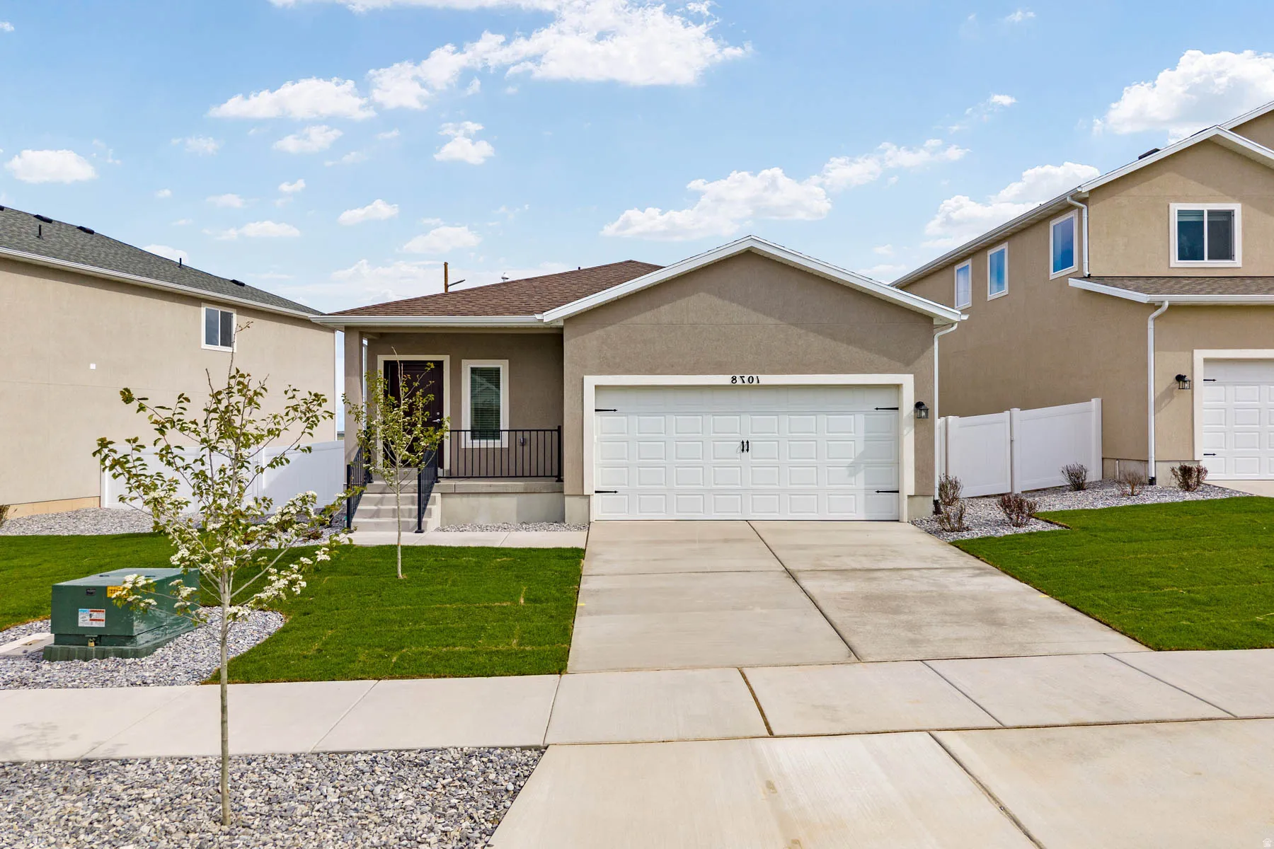 Contemporary stucco exterior with an attached two-car garage