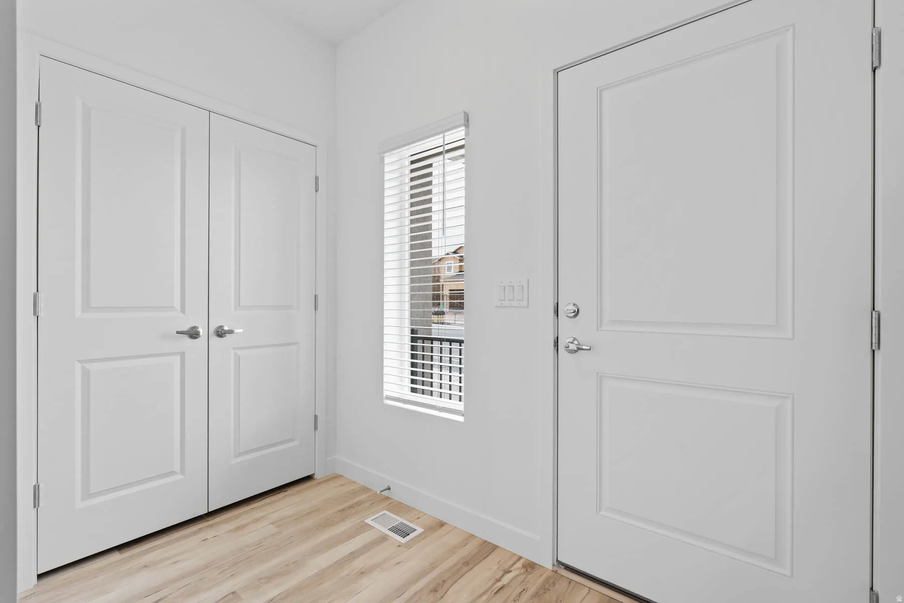 Entryway featuring light wood-finish flooring and white walls