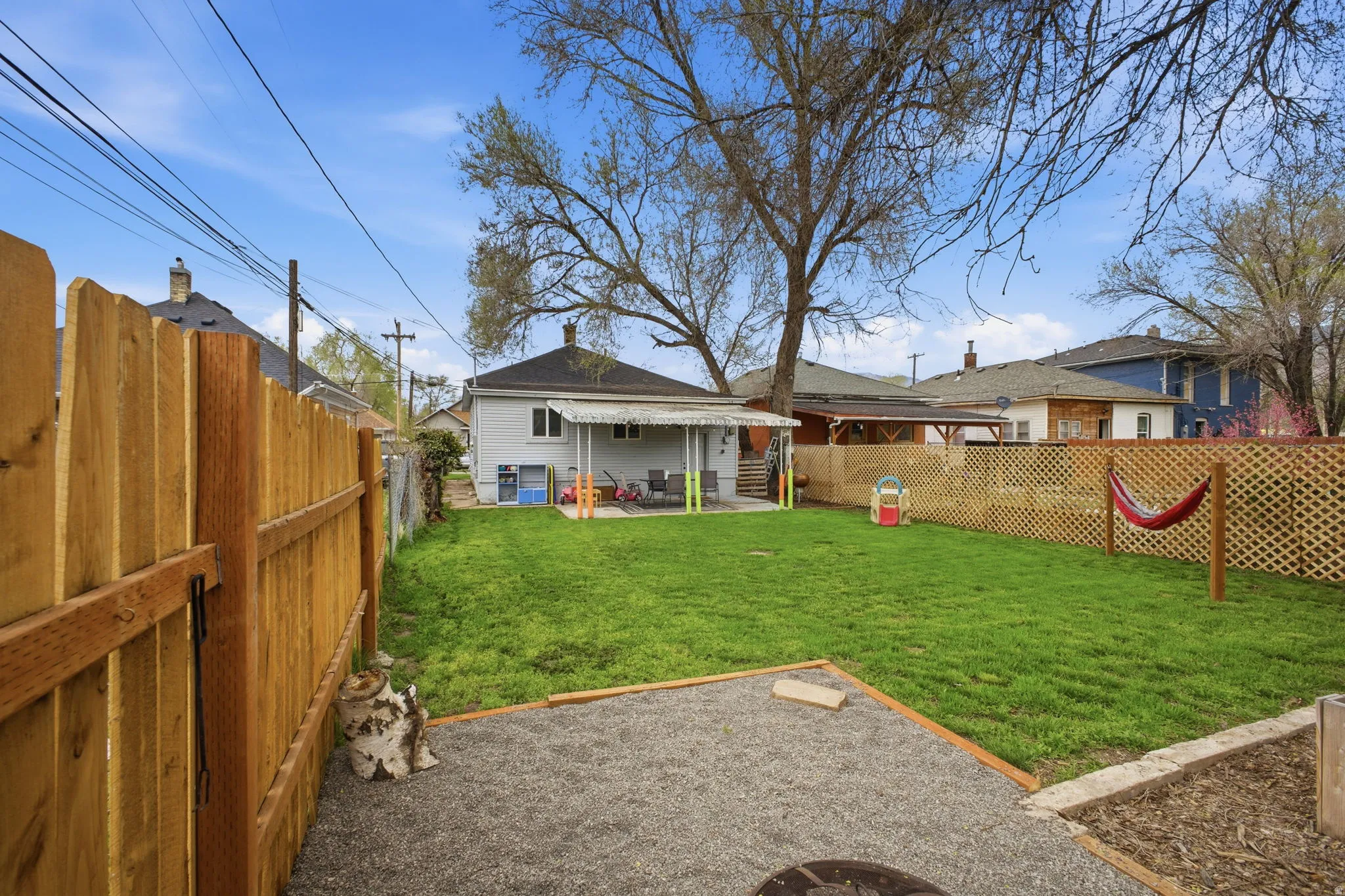 Fenced backyard with a patio area