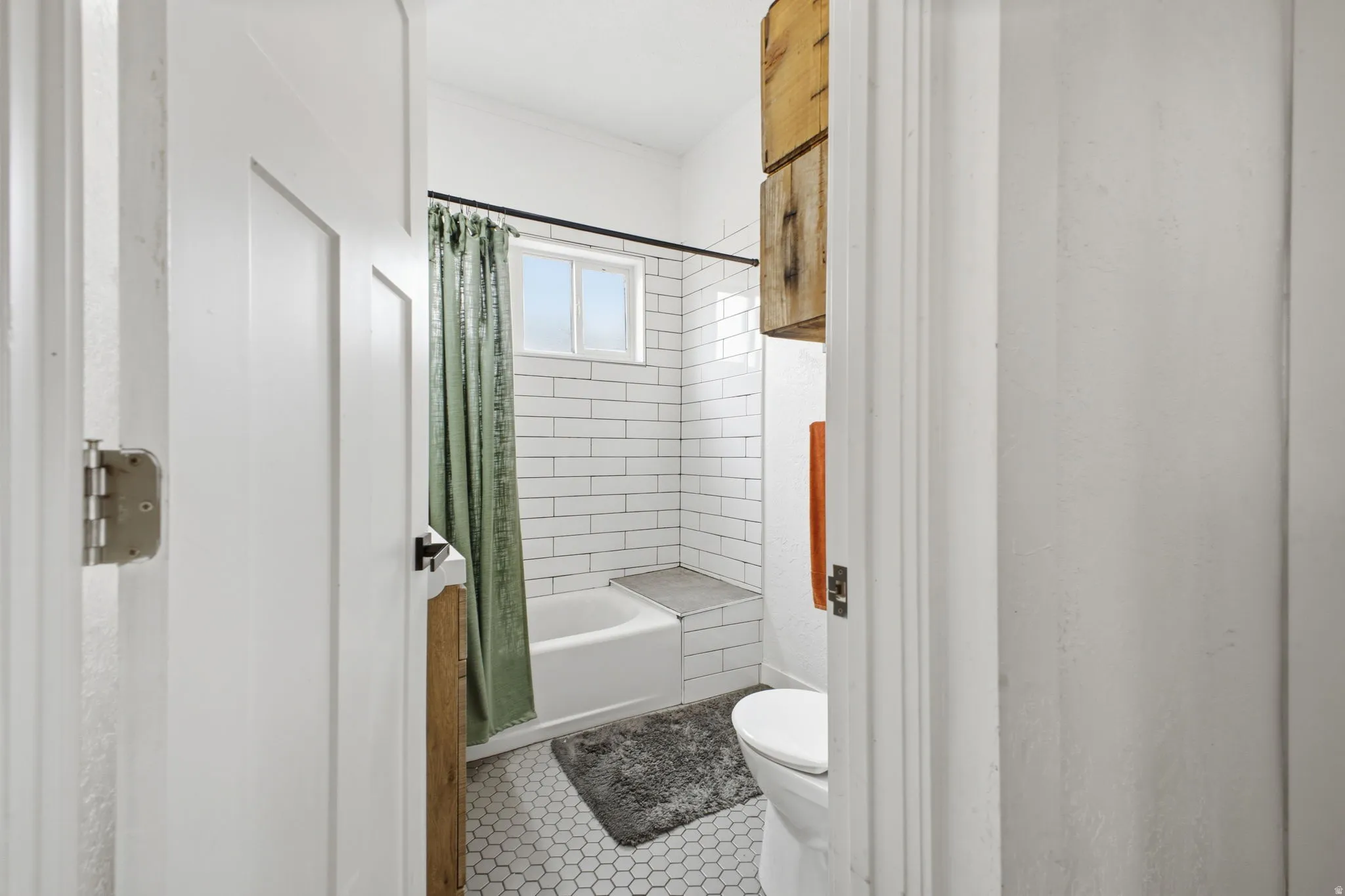 Bathroom featuring shower / bath combo with shower curtain and light tile patterned floors