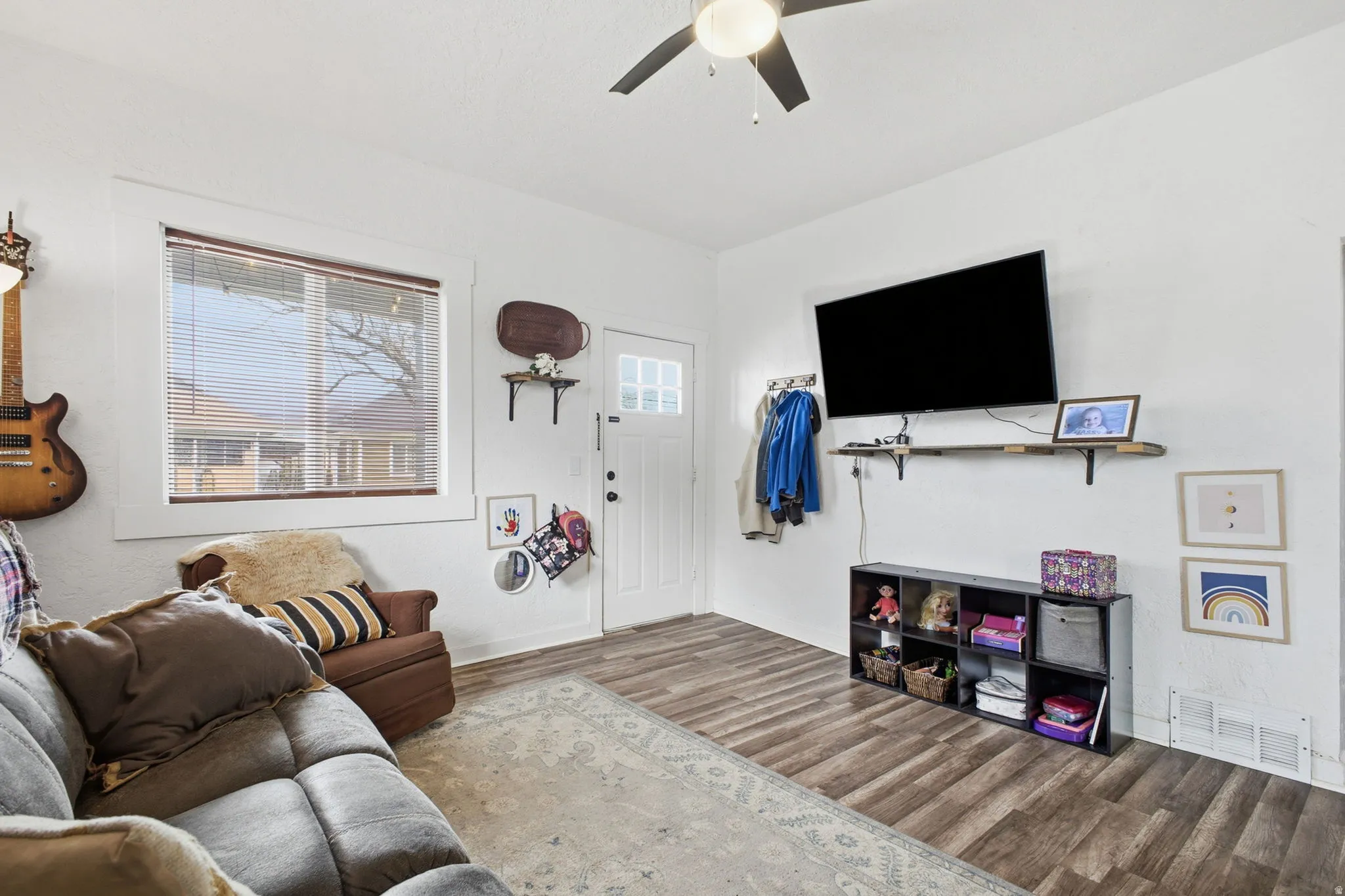 Living room with wood finished floors and ceiling fan