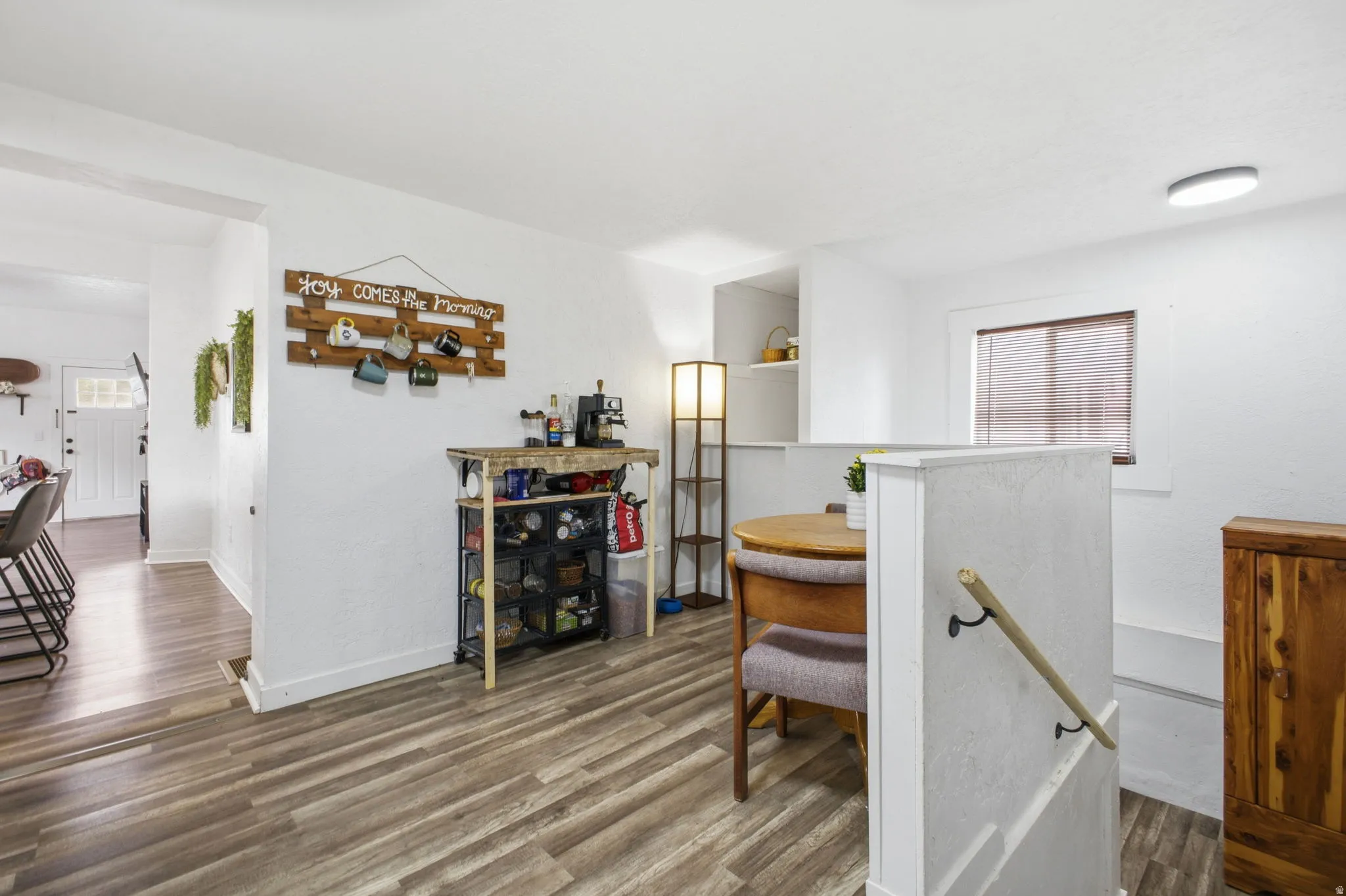 Corridor featuring dark wood-style flooring and baseboards