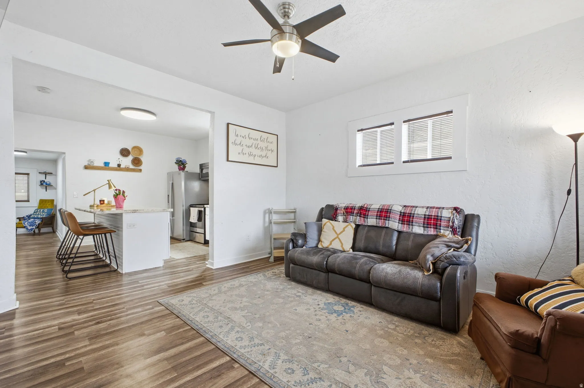 Living room with a ceiling fan and wood finished floors