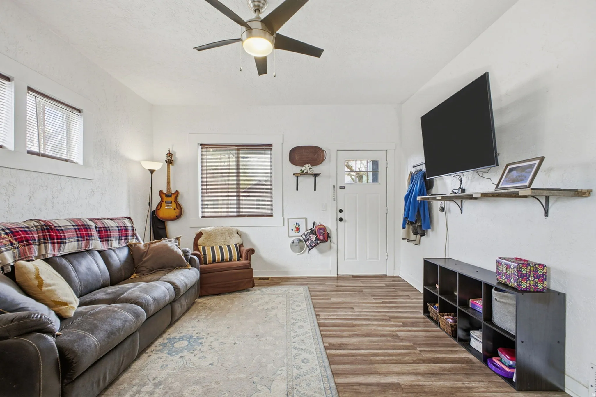 Living room with wood finished floors and ceiling fan