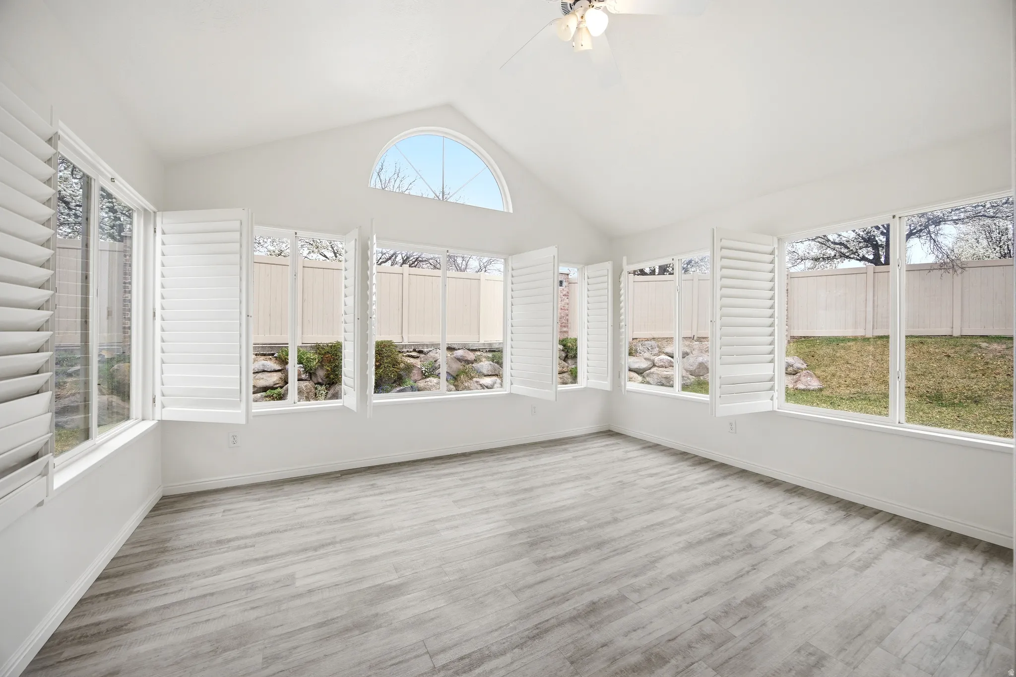 Unfurnished sunroom with plenty of natural light and wood finished floors
