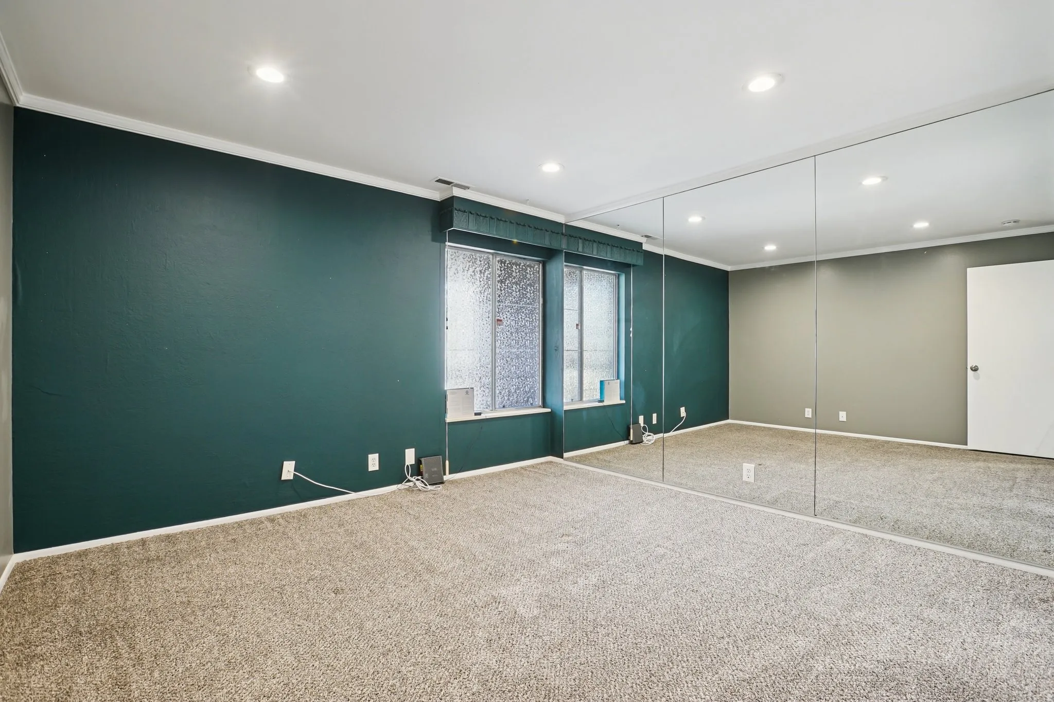 Carpeted empty room with ornamental molding and recessed lighting