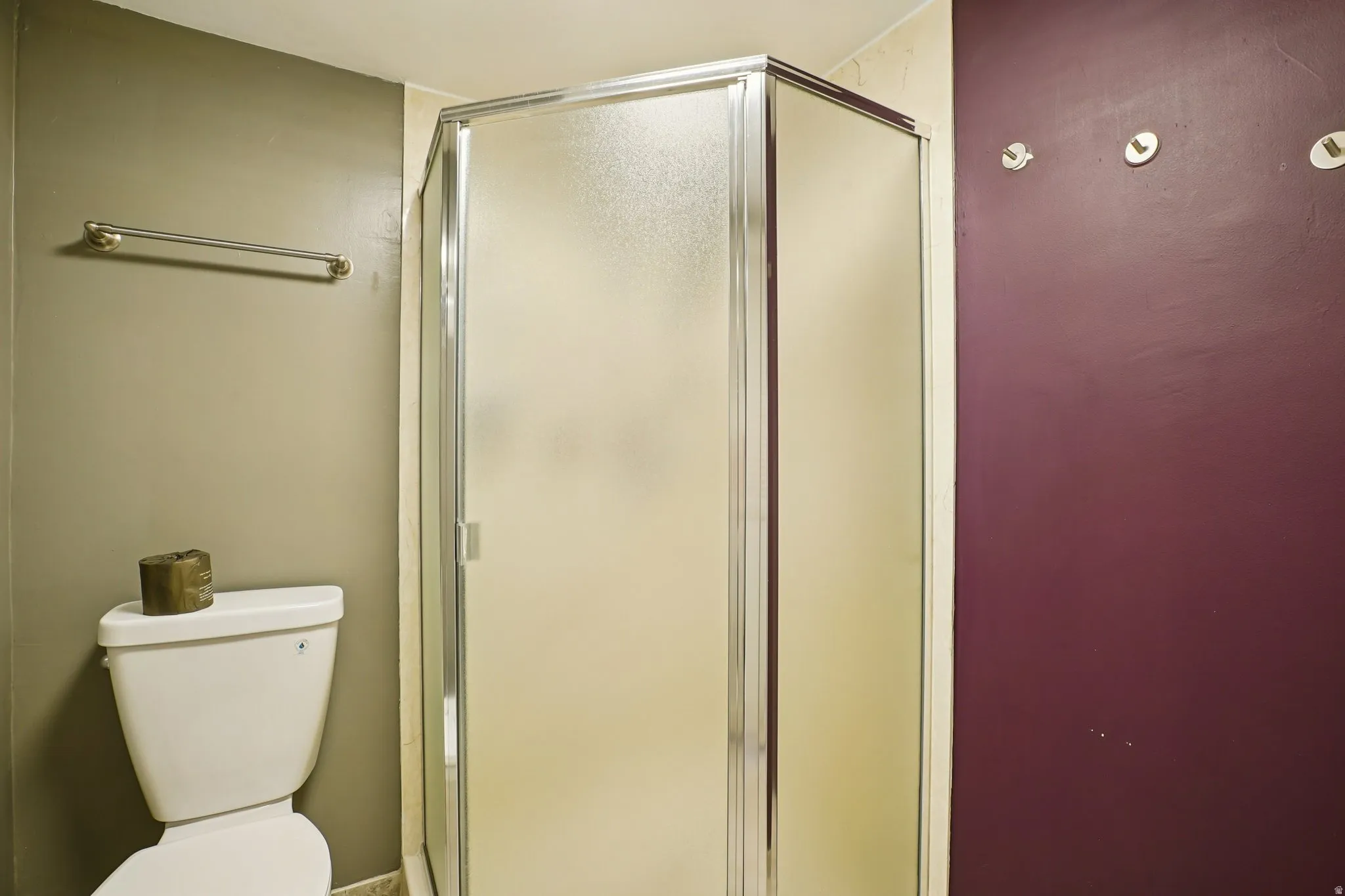 Full bath with a stall shower and toilet