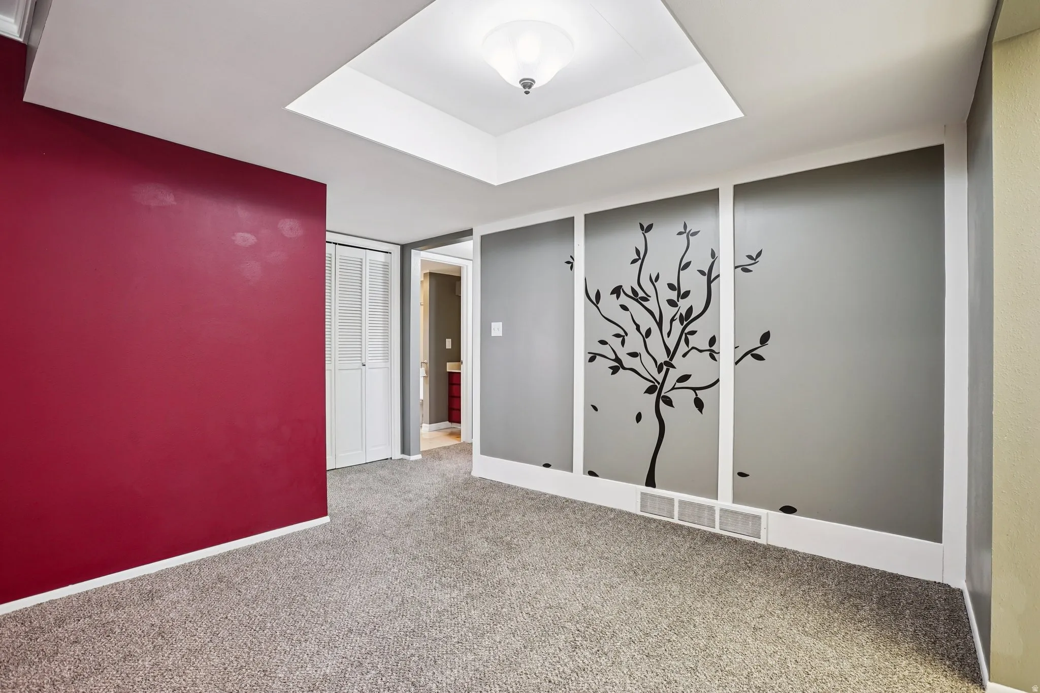 Spare room featuring light colored carpet and baseboards